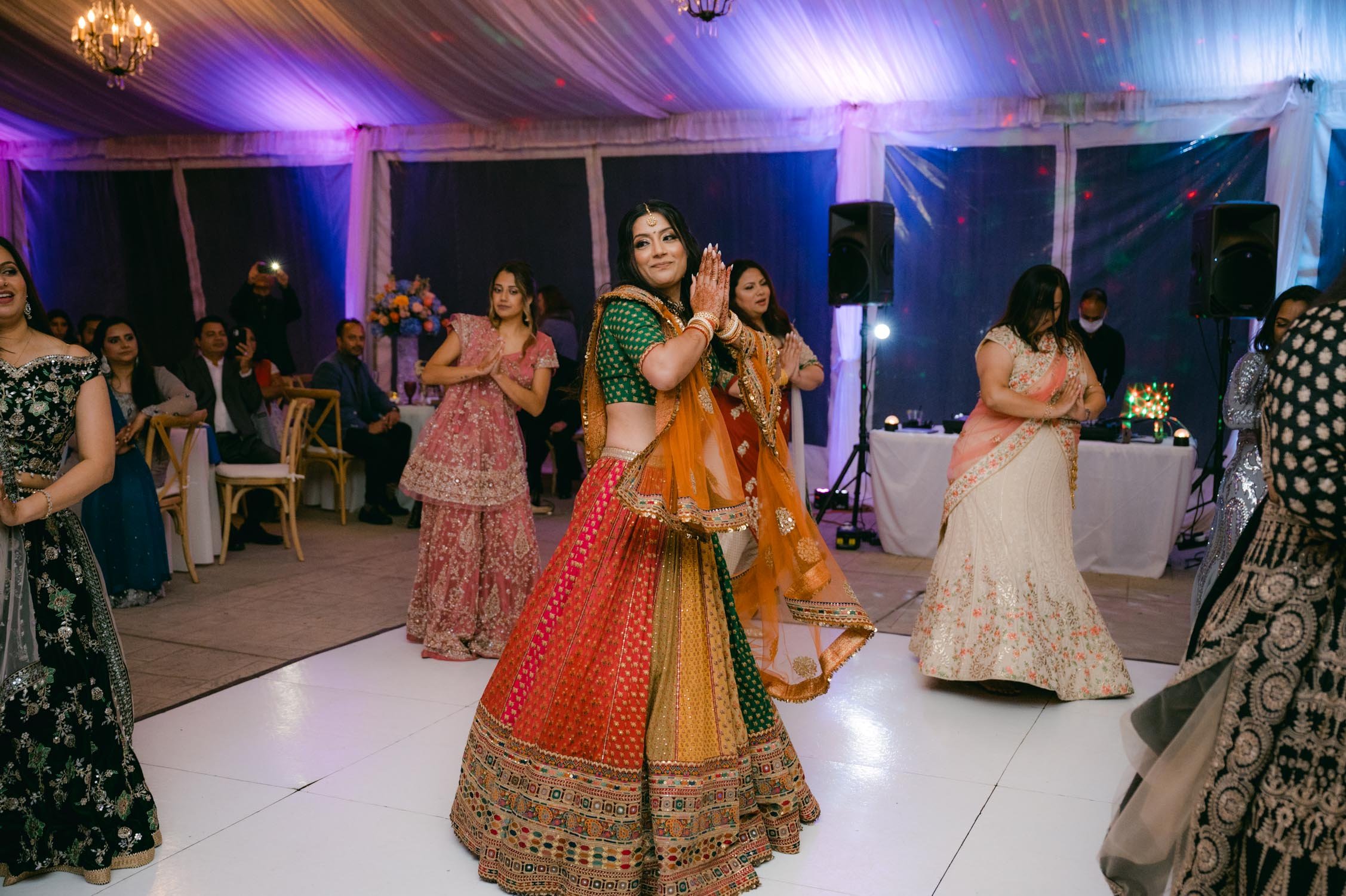 Indian wedding reception, photo of bride dancing for the groom