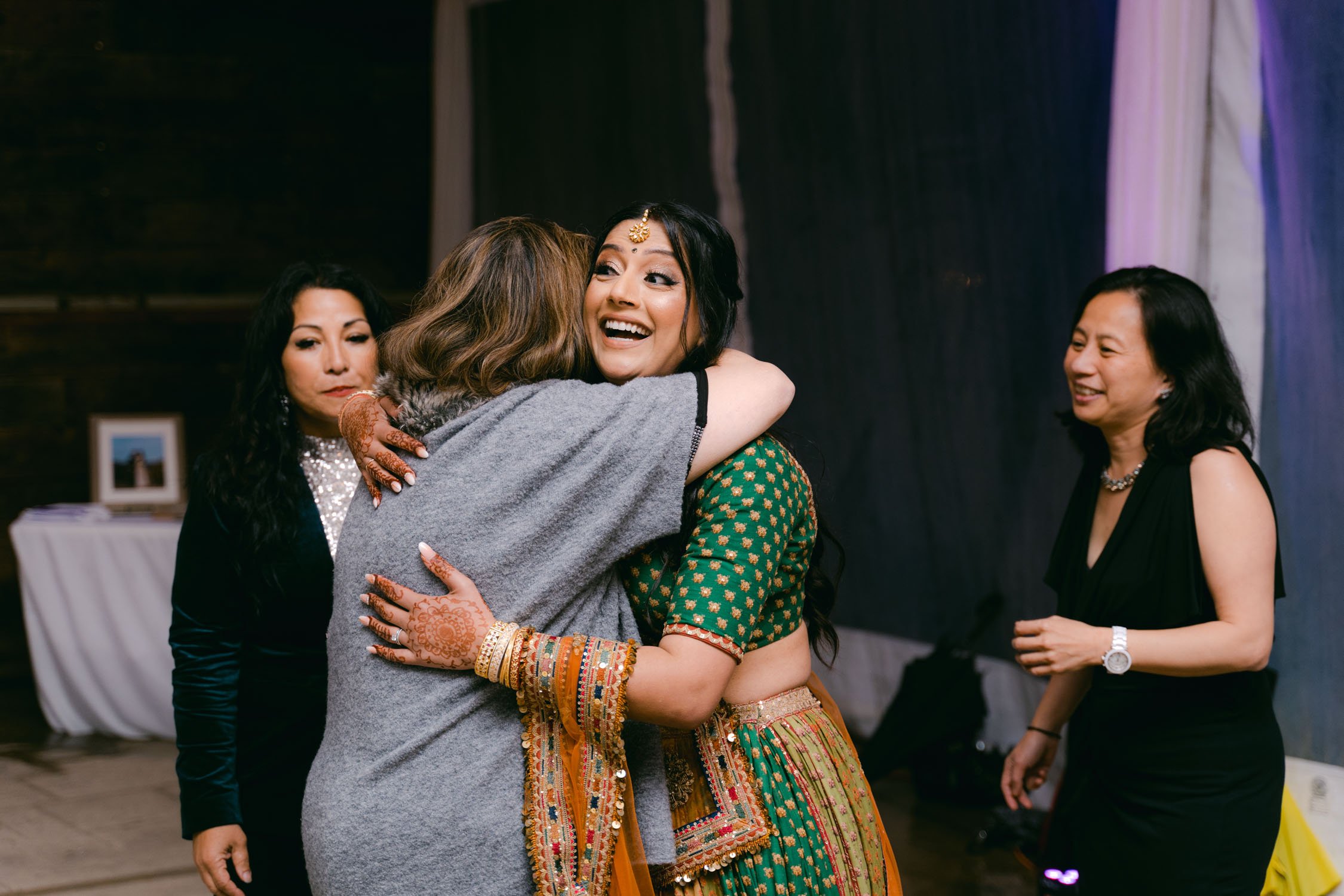 Indian wedding reception, photo of bride hugging the guests