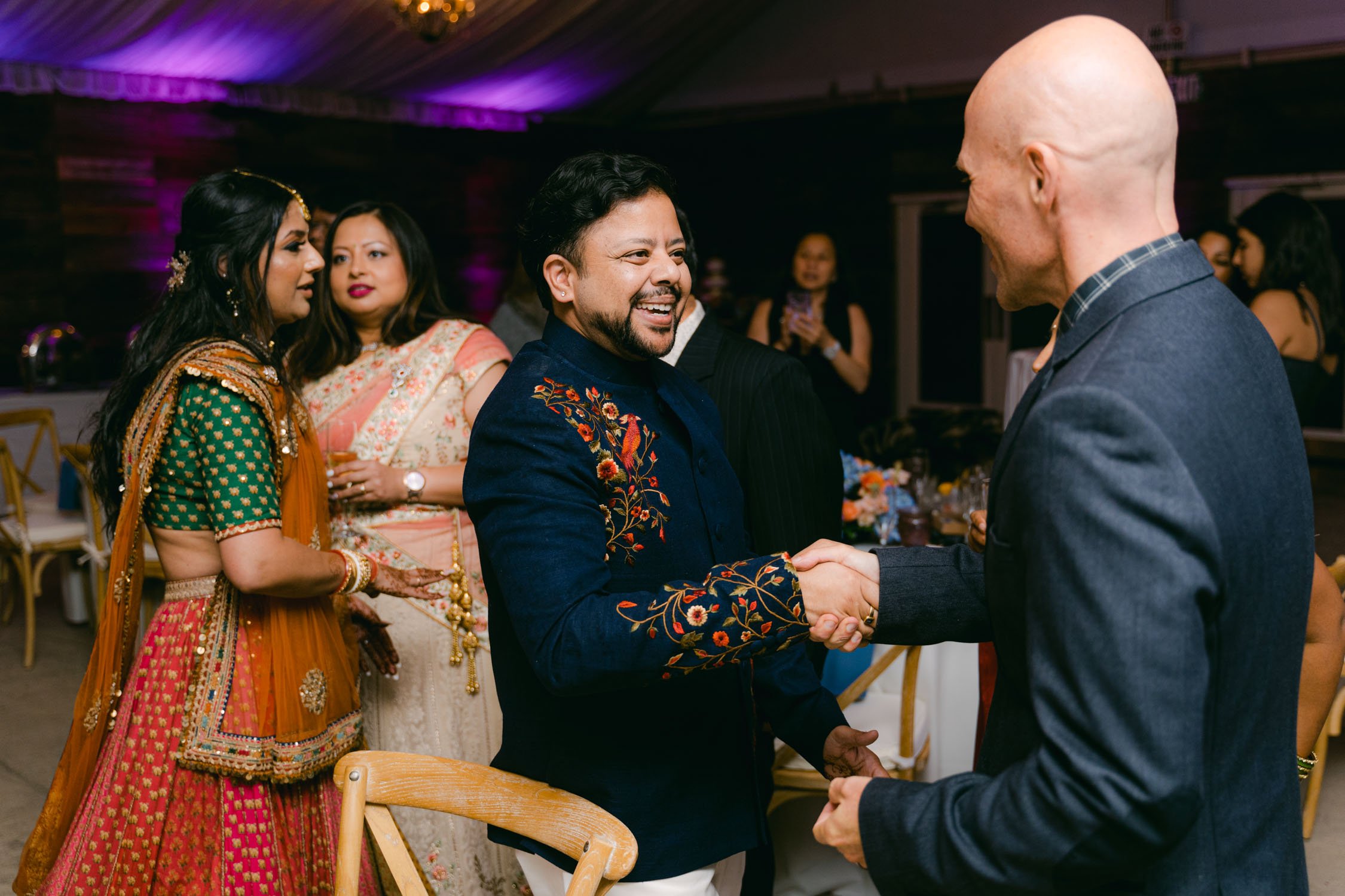 Indian wedding reception, photo of groom shaking hands