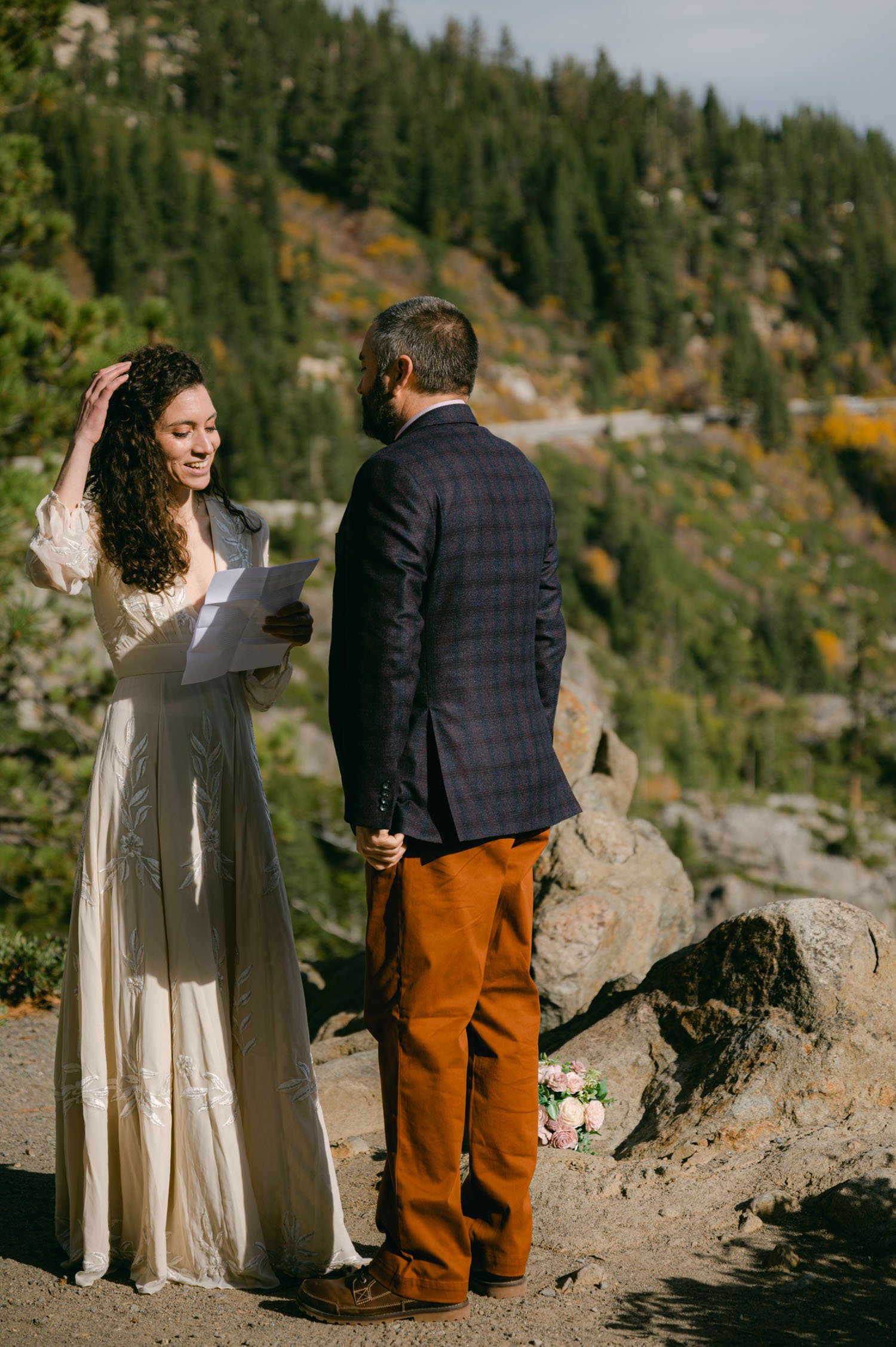 Emerald Bay Elopement, photo of couple reading their vows on a private outlook