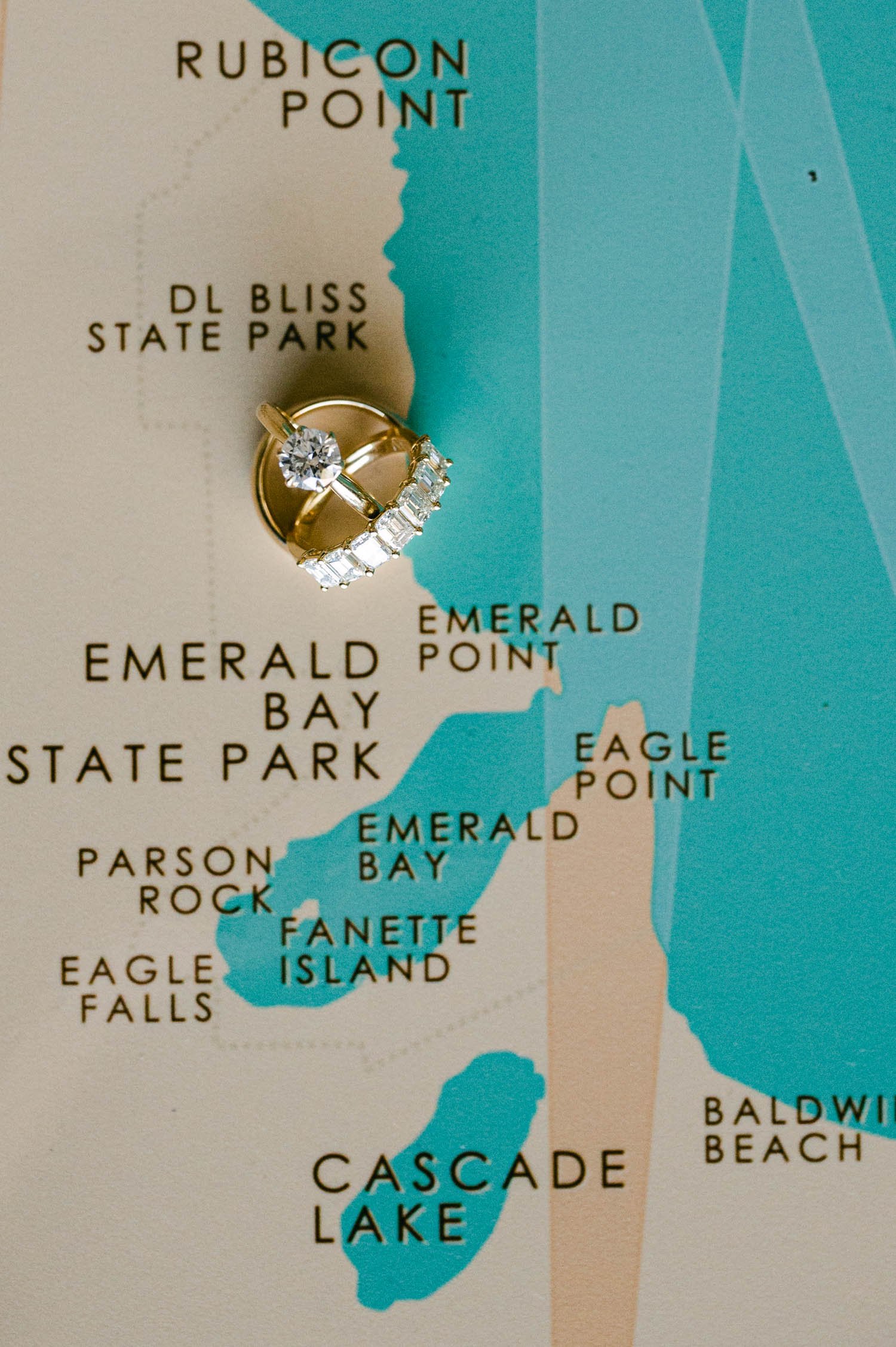 Tahoe Bleu Wave Wedding photo of rings on top of an emerald bay map