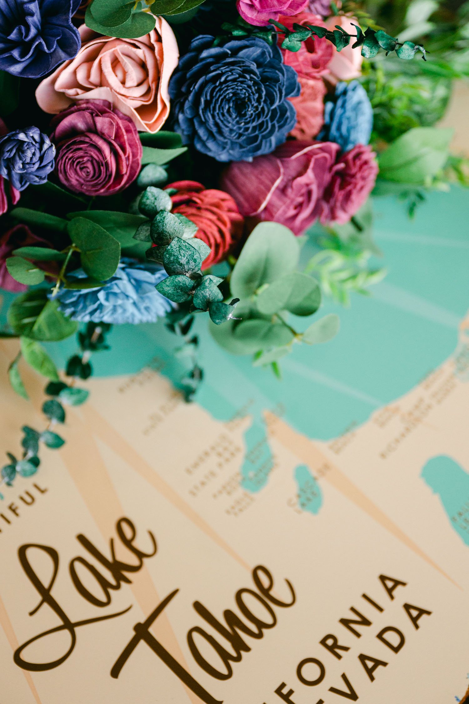 Tahoe Bleu Wave Wedding photo of a colorful wooden bouquet on top of a lake tahoe map