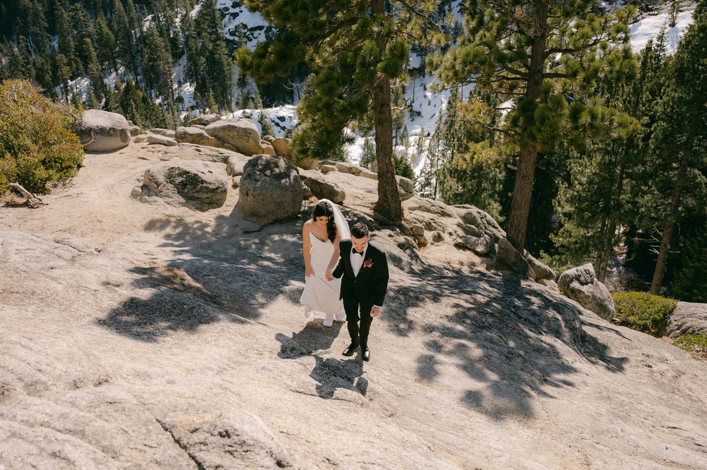 Tahoe Bleu Wave Wedding photo of couple walking up a granite slab