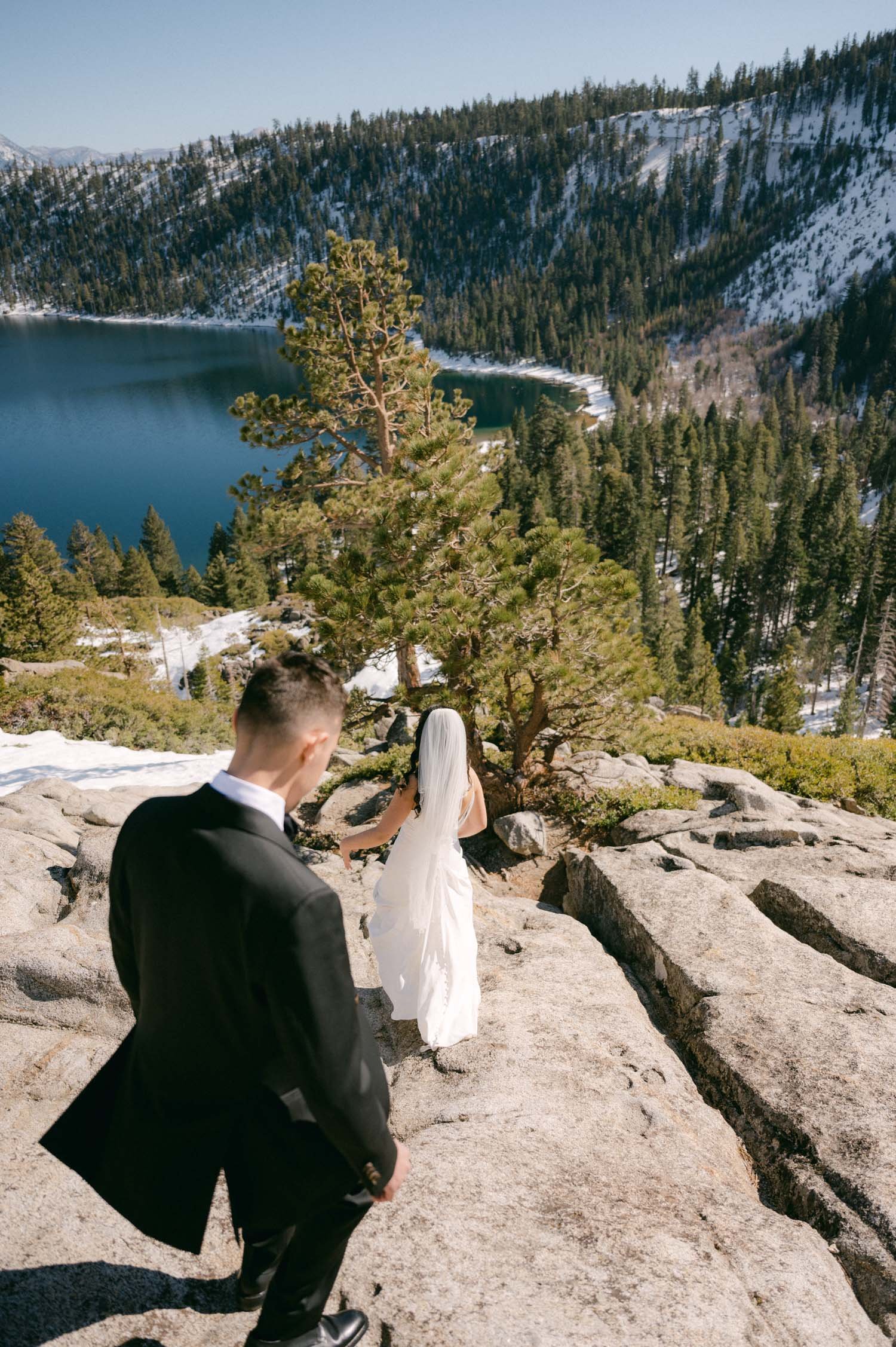 Tahoe Bleu Wave Wedding photo of couple walking down a slab of rock