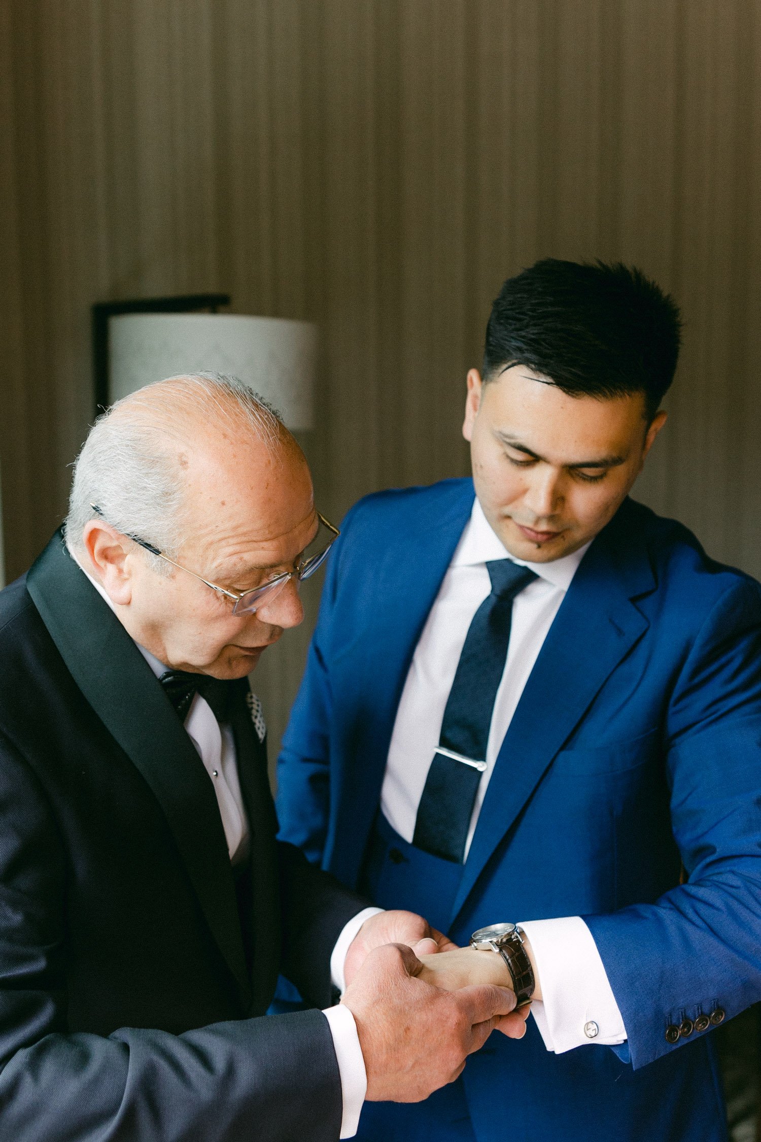 Edgewood Tahoe wedding photos, photo of groom's dad helping him with his watch
