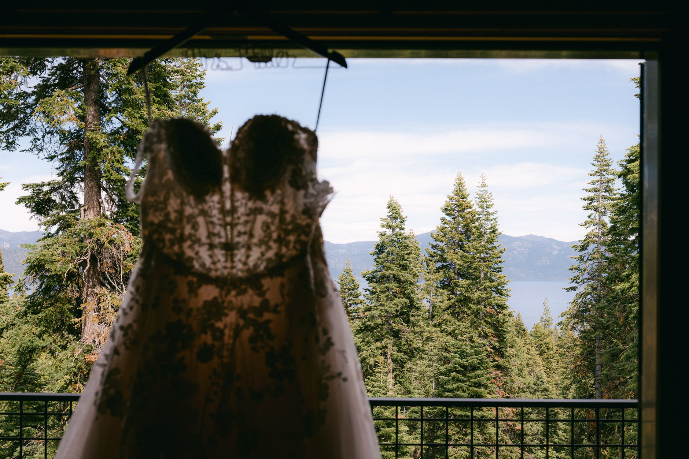 Lake Tahoe elopement, photo of wedding dress with Tahoe in the backdrop