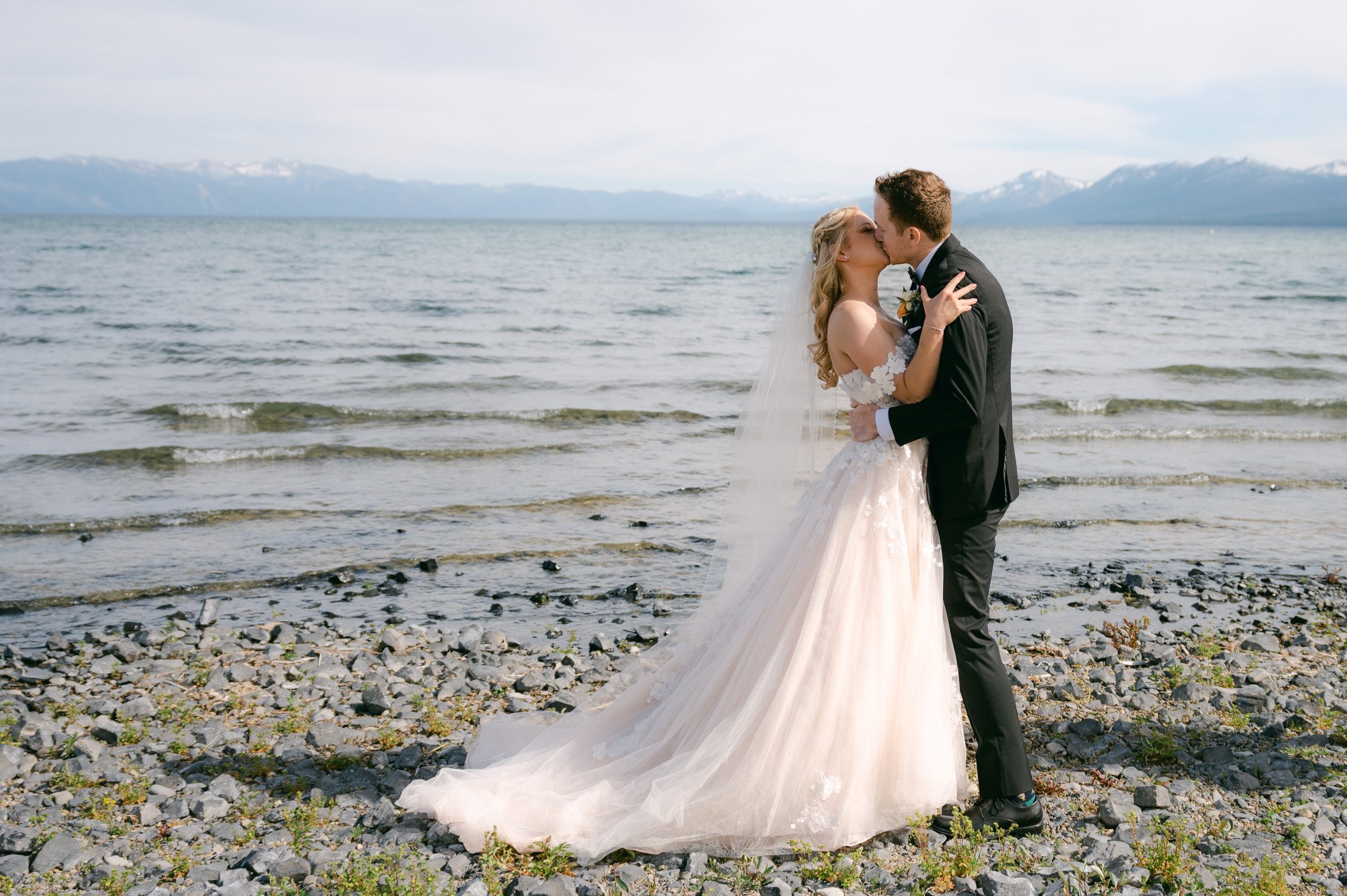 Lake Tahoe elopement, photo of couple having their first kiss by the lake