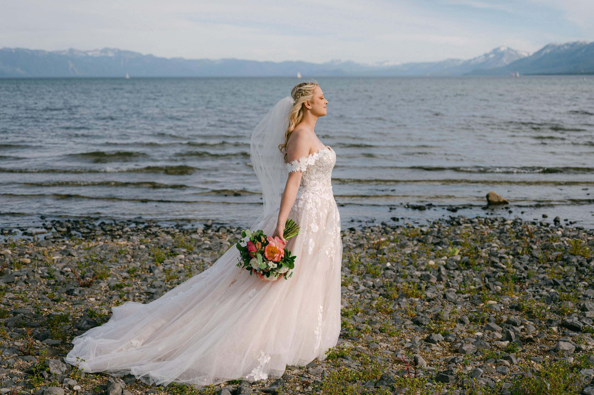 Lake Tahoe elopement photo of bride by the lake