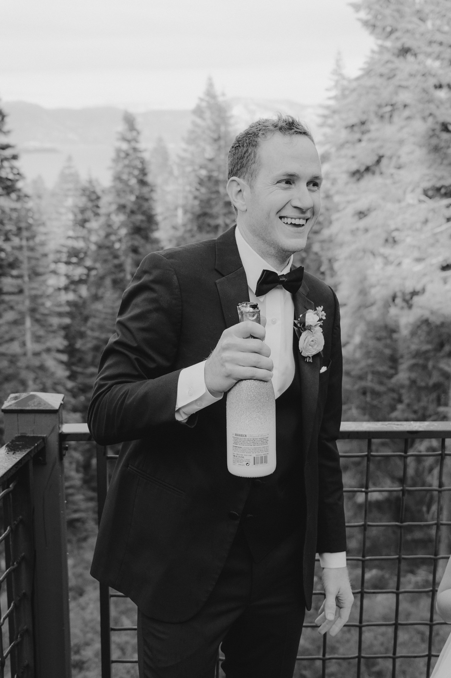 Lake Tahoe elopement photos, photo of groom with his champagne bottle
