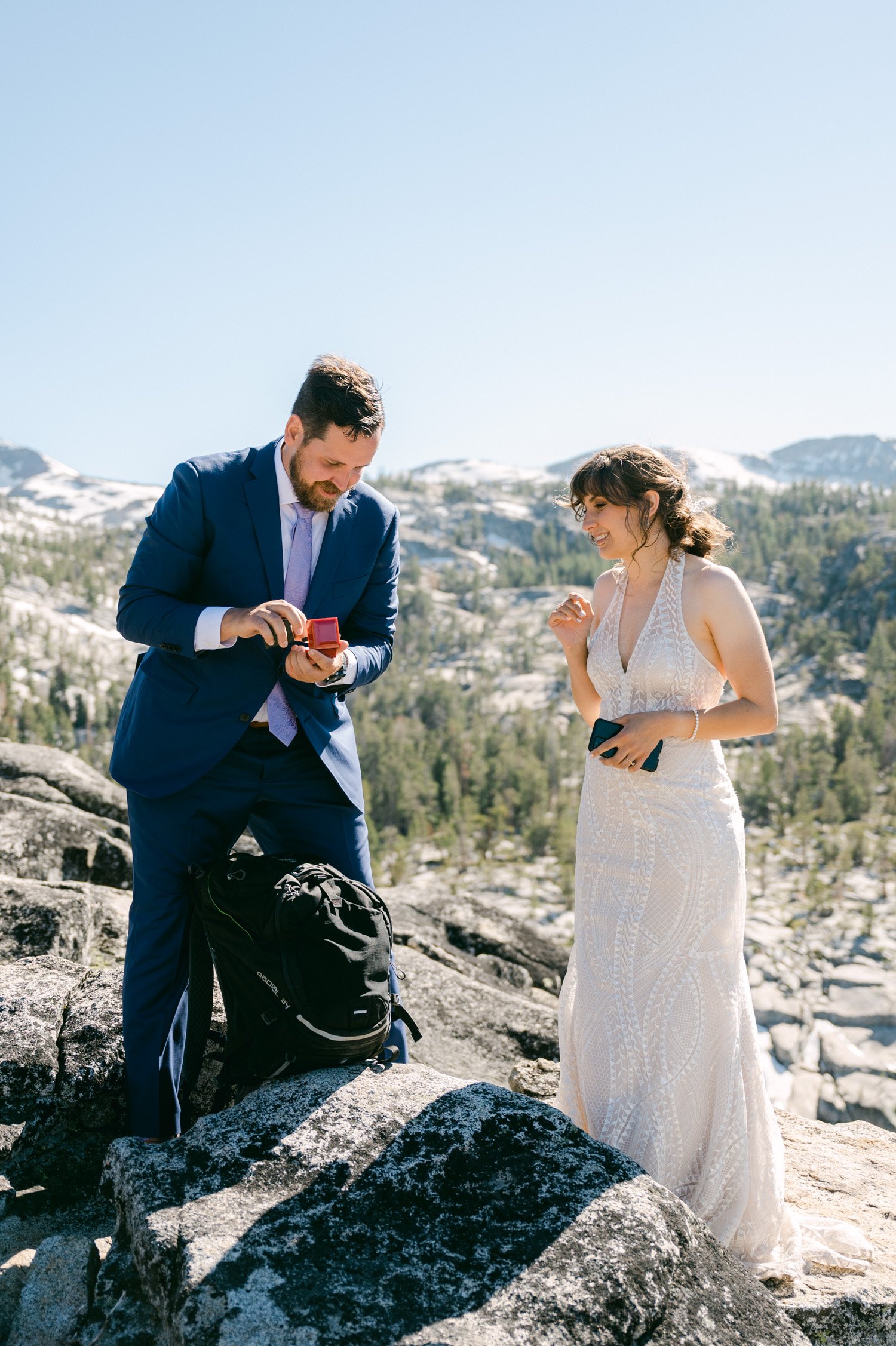 Adventure elopement in Lake Tahoe, photo of couple getting their wedding rings
