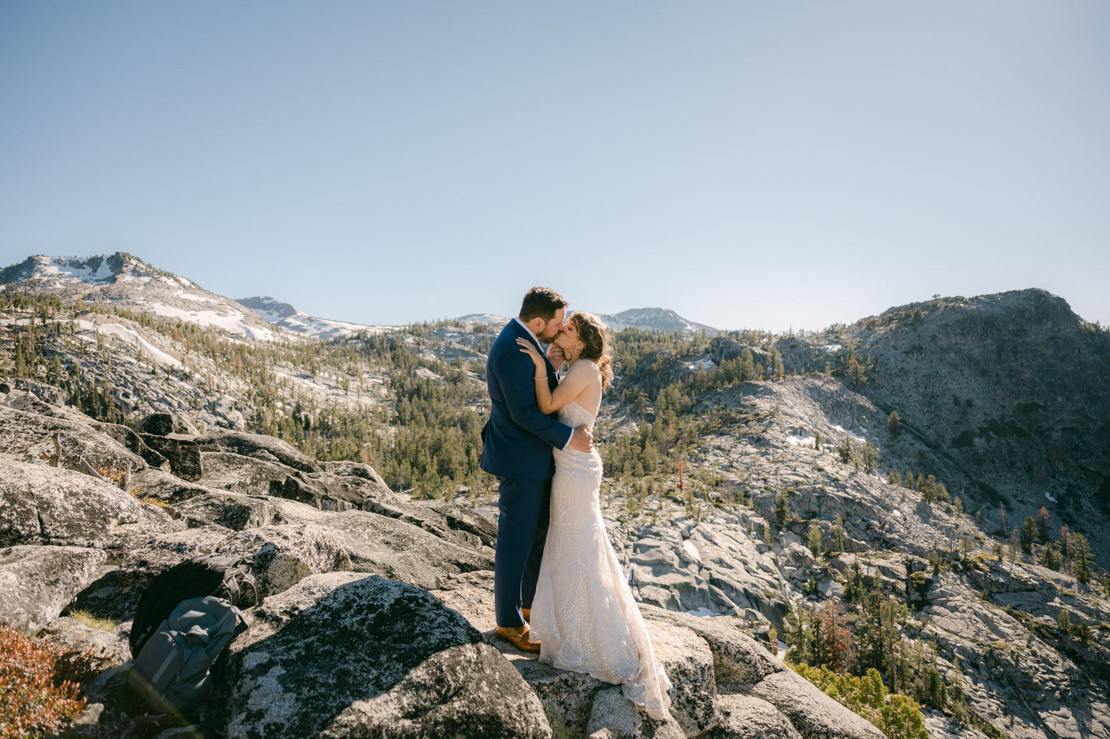 Adventure elopement in Lake Tahoe, photo of couple kissing on top of a mountain 