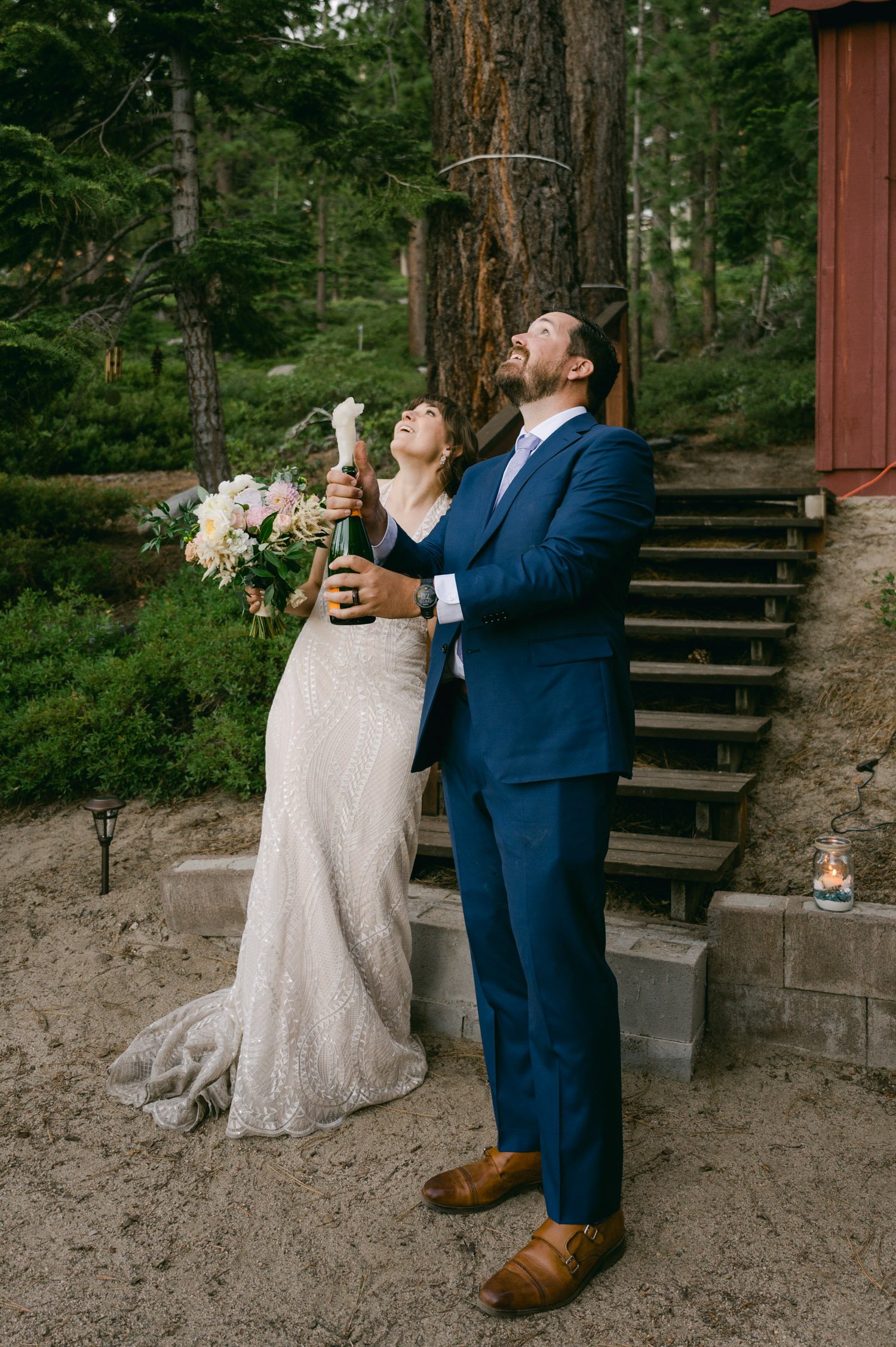 Adventure elopement in Lake Tahoe, photo of couple popping champagne 