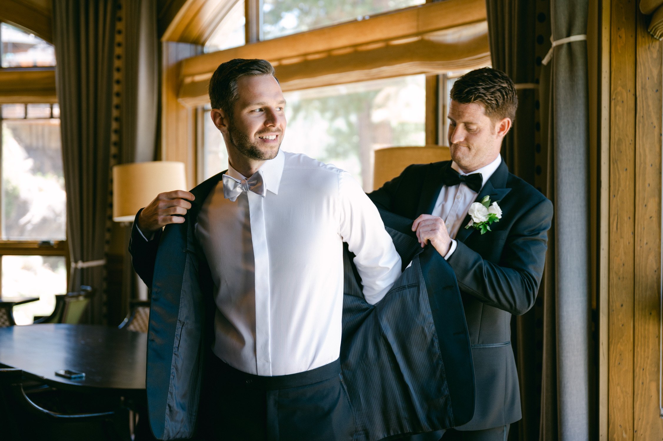Martis Camp wedding photo of groom putting his suit on
