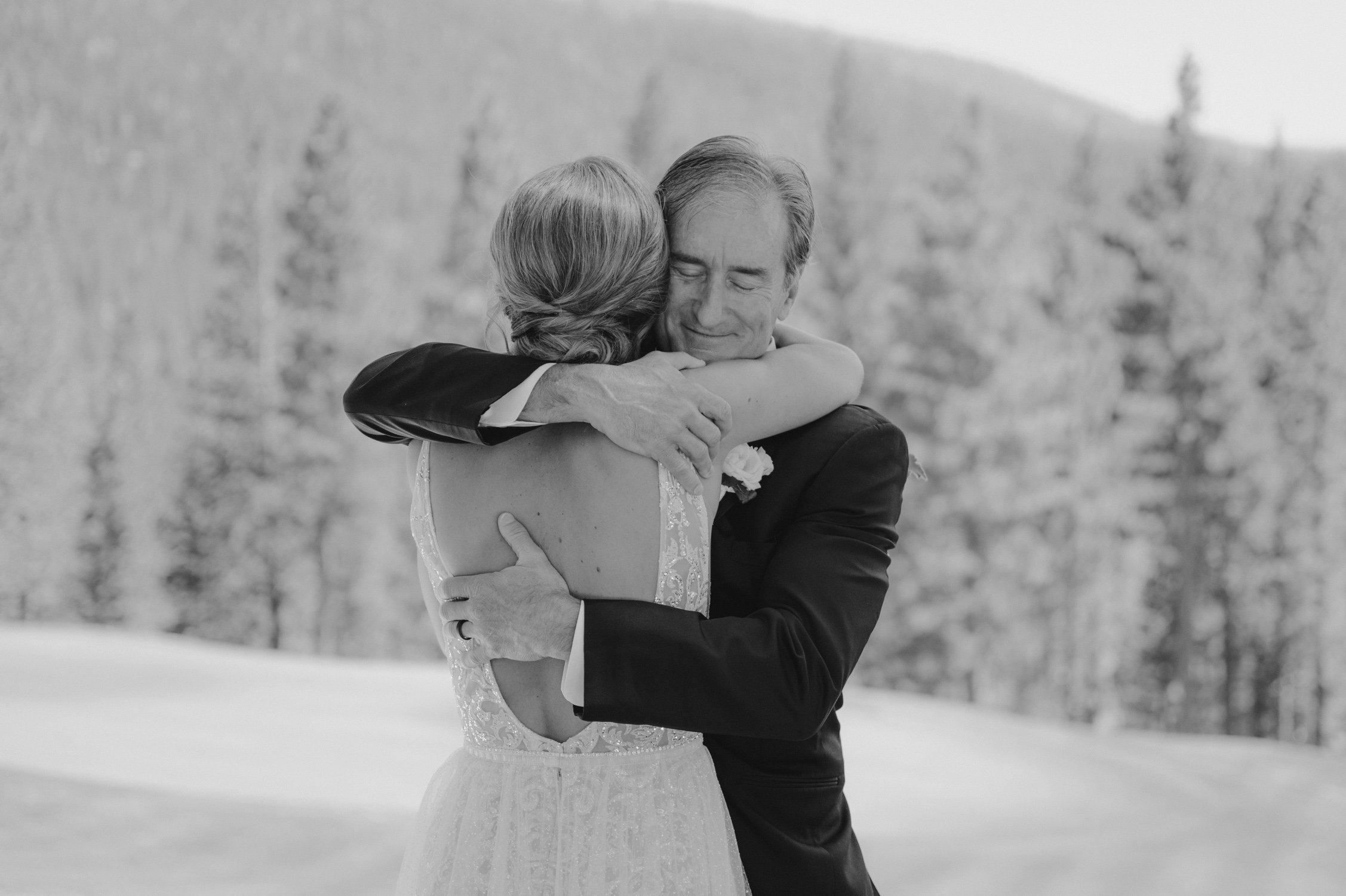 Martis Camp Wedding photo of a dad hugging his daughter 