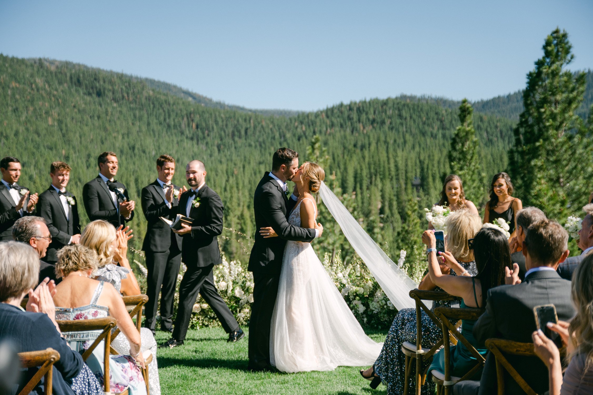 Martis Camp wedding, photo of couple having their first kiss as husband and wife