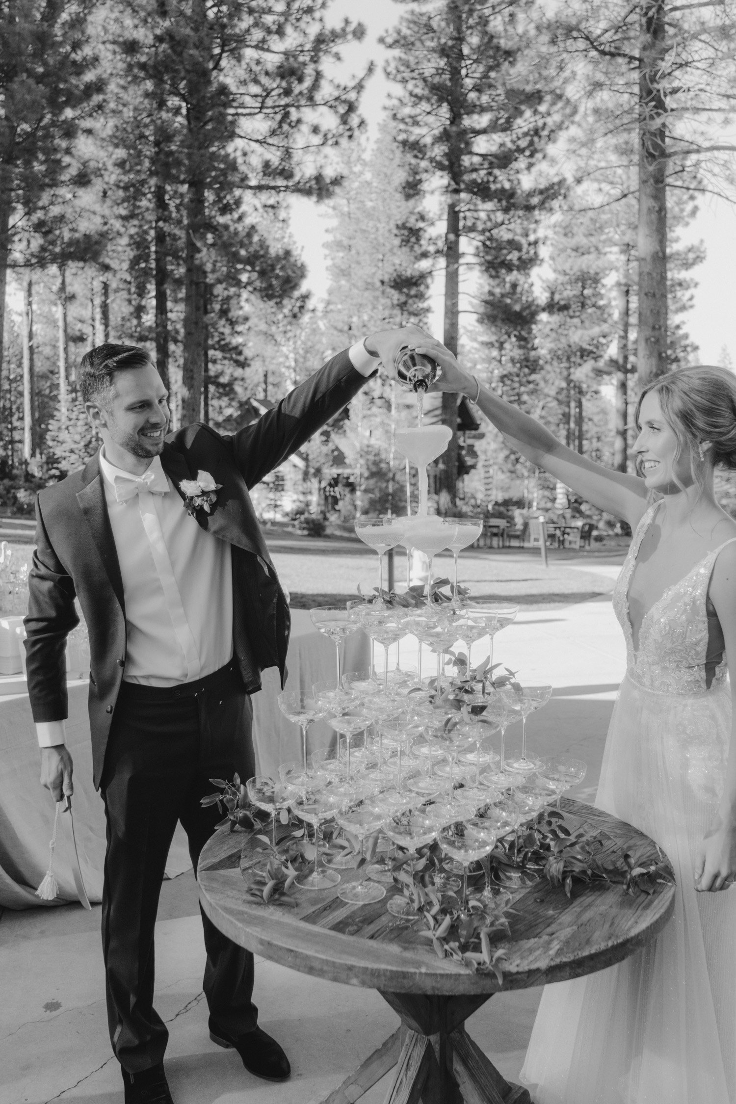 Martis Camp wedding, photo of couple sabering champagne 