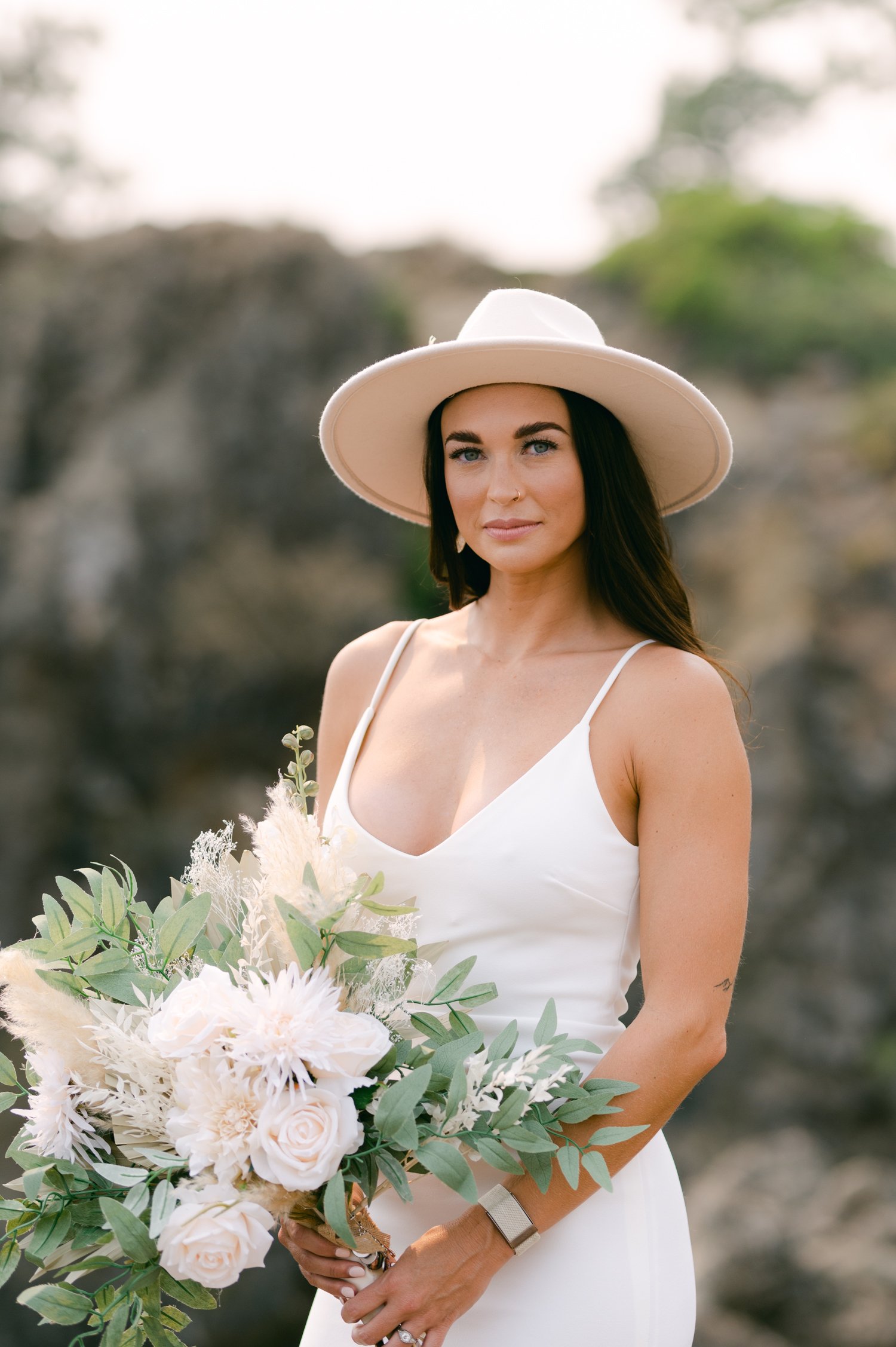 Lake Tahoe Yacht wedding, photo of bride wearing a fedora and a simple/classic white dress