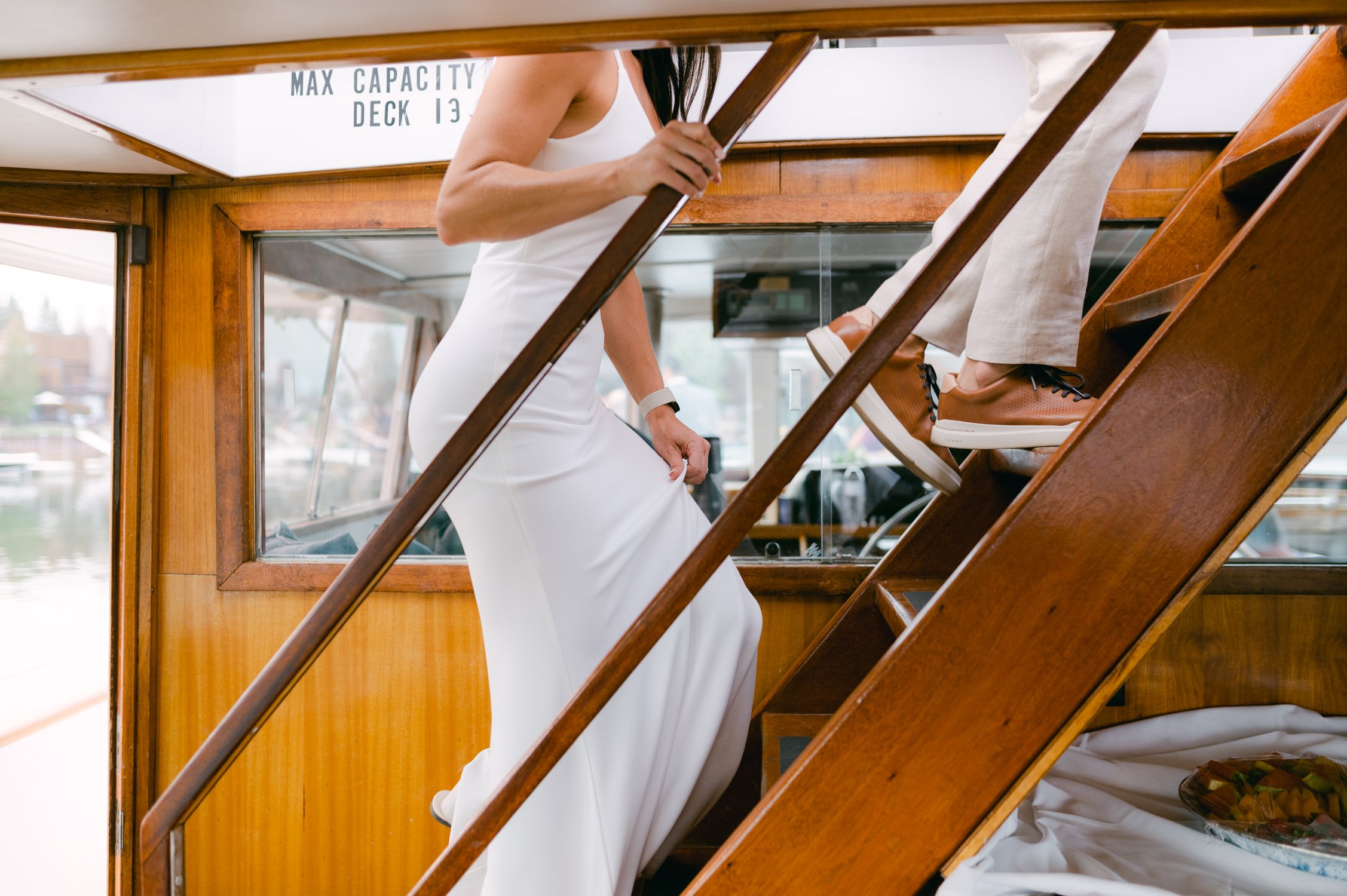Lake Tahoe Yacht wedding, photo of couple walking up the first deck of the boat