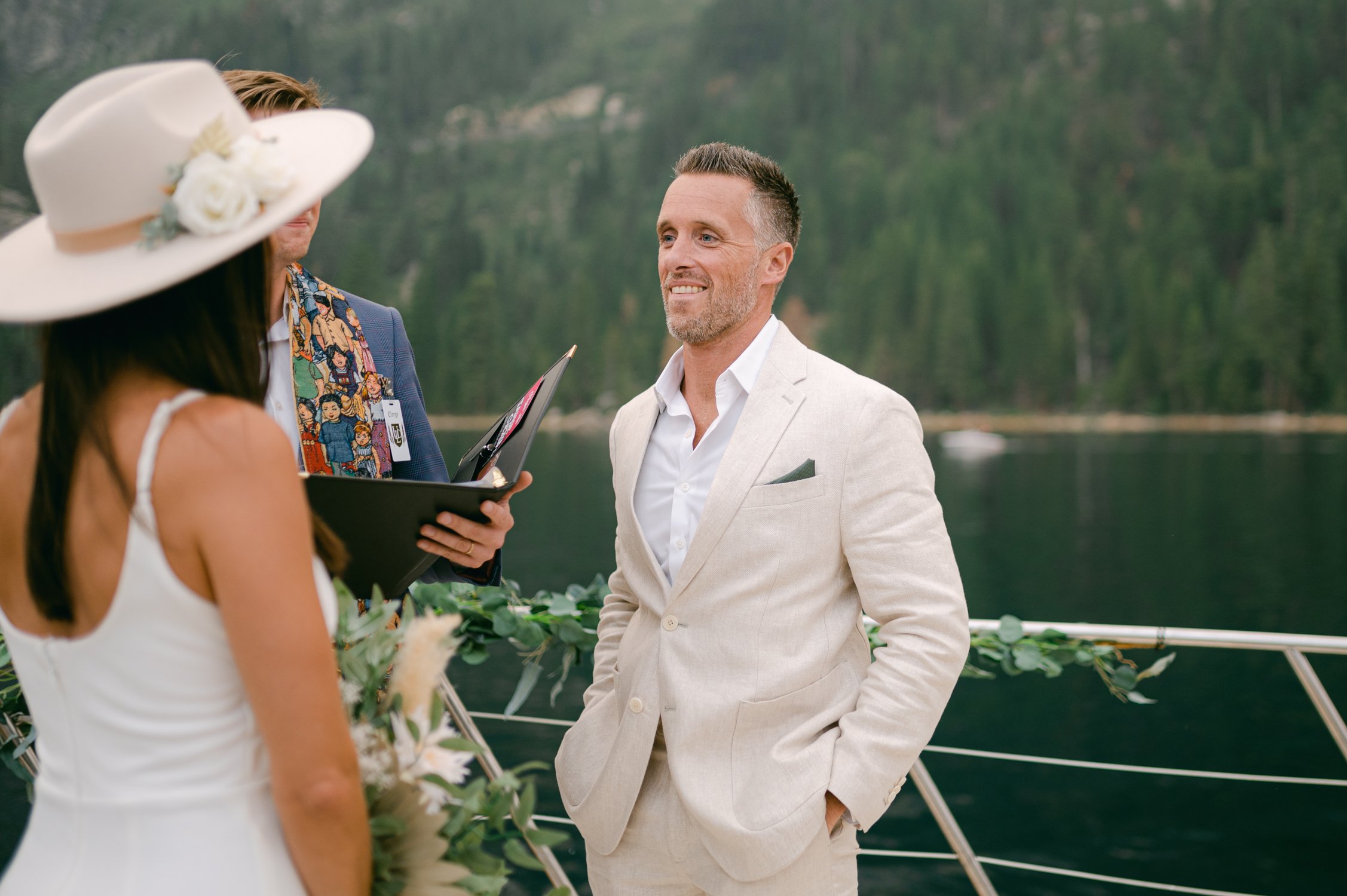 Lake Tahoe Yacht wedding, photo of couple having their wedding ceremony on a boat in front of emerald bay