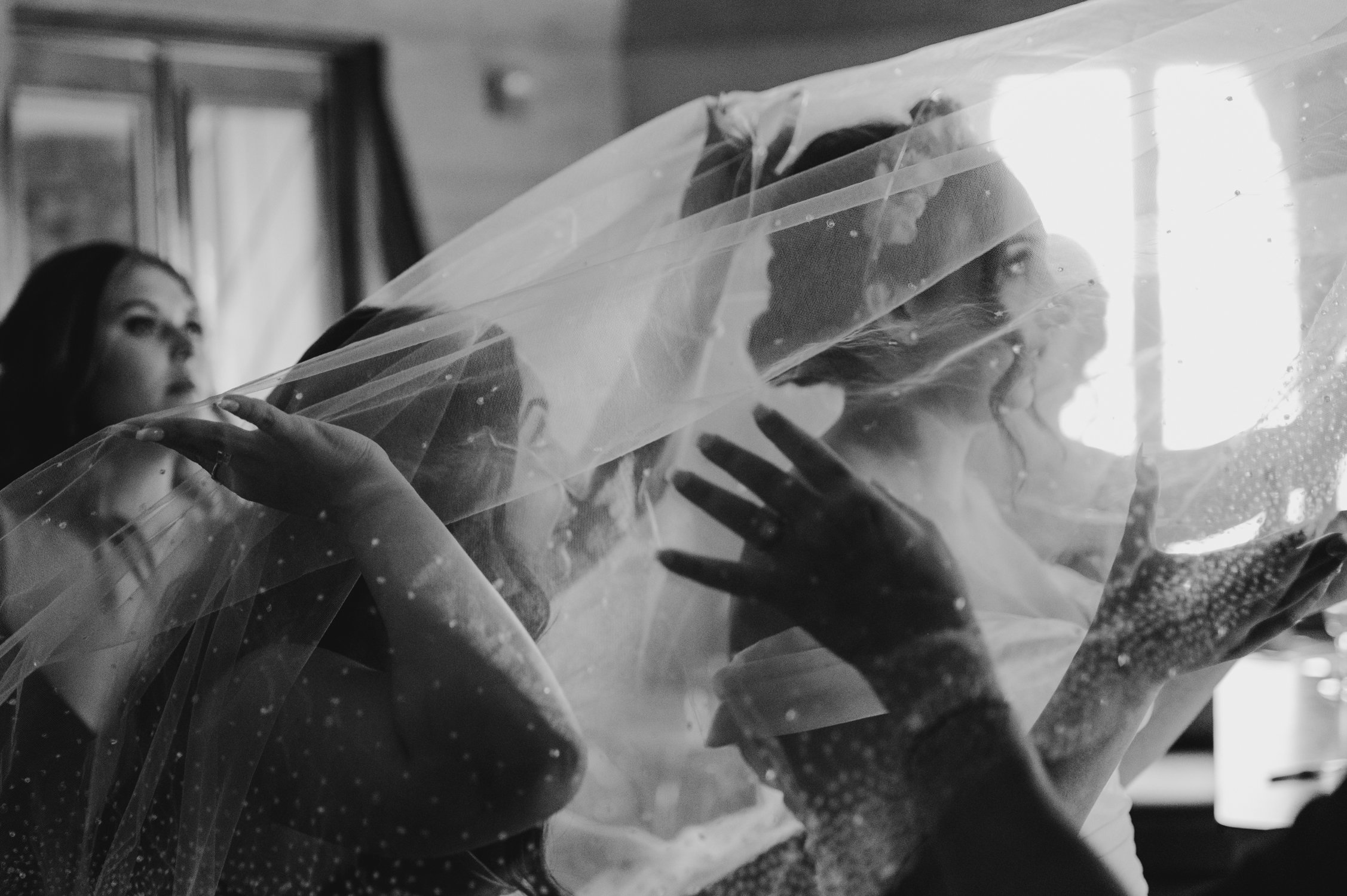 Nakoma Resort Wedding photography, photo of bride putting her jeweled cathedral veil on