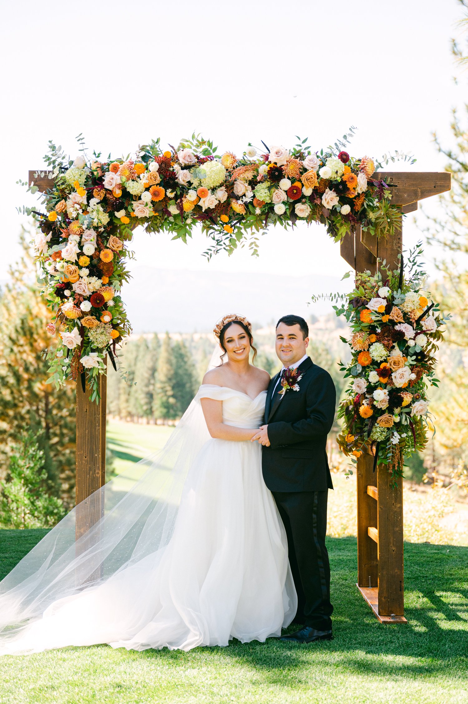 Nakoma Resort Wedding photography, photo of couple underneath their floral arch