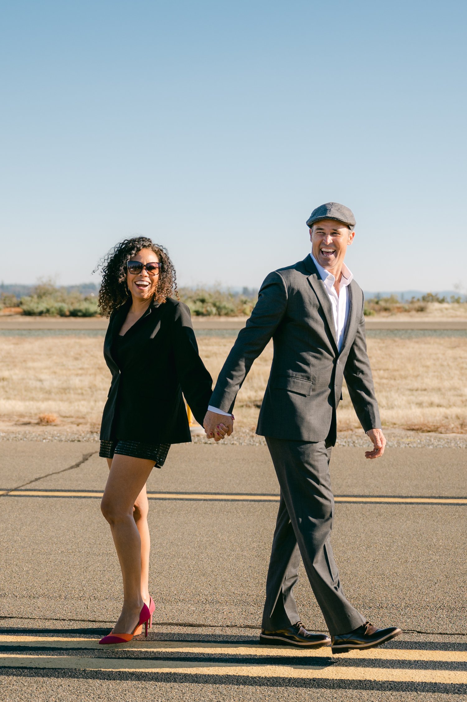 Airport photoshoot, photo of couple walking on airport runway.  
