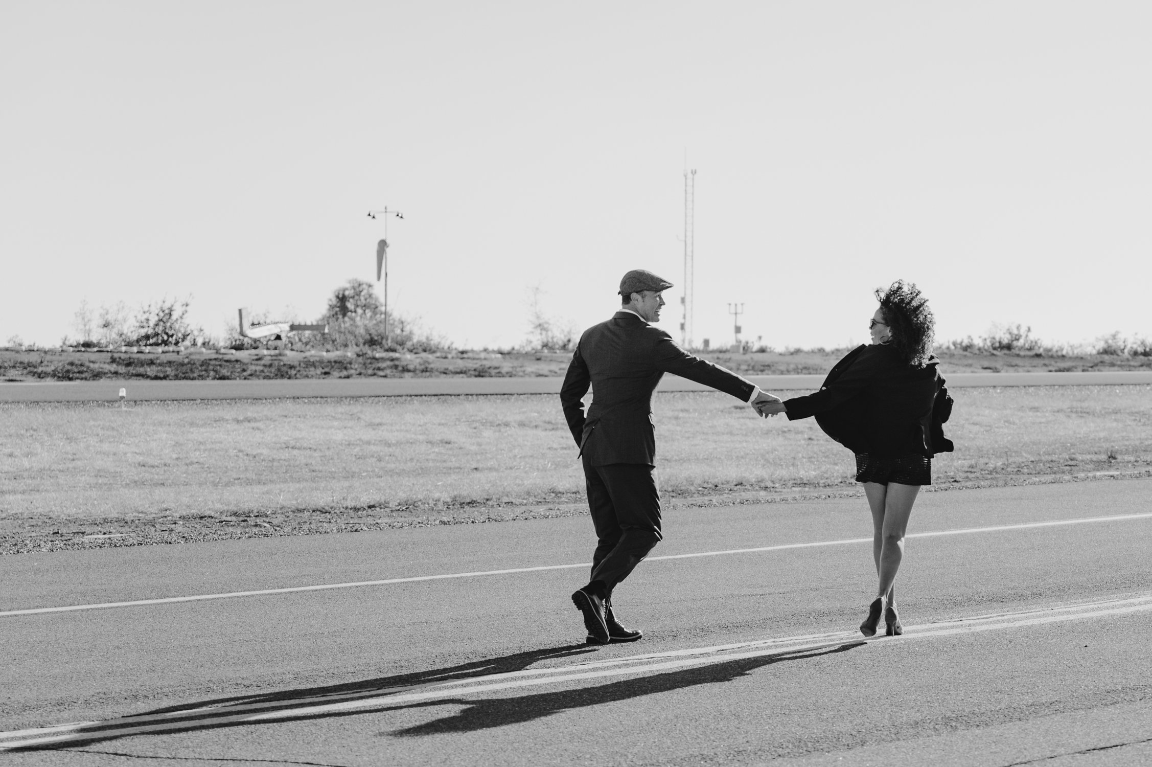Airport photoshoot, photo of couple running on the runway 