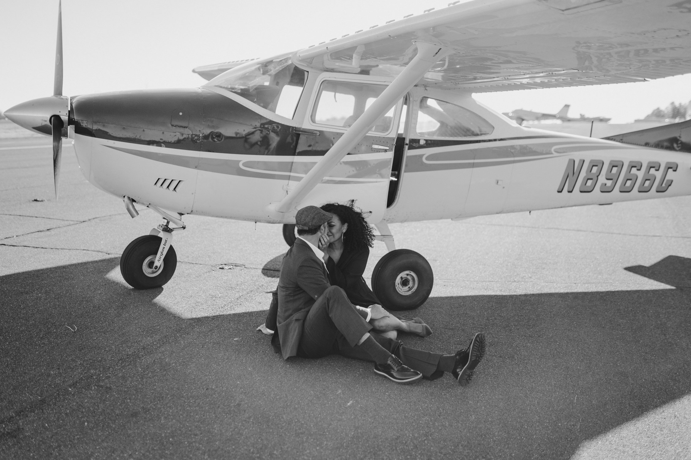 Airport photoshoot, photo of couple sitting by the plane