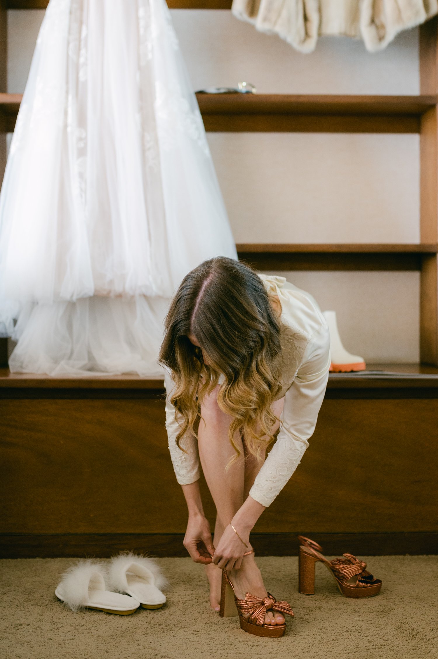 An elopement during a historic winter in tahoe, photo of bride putting on her heals 