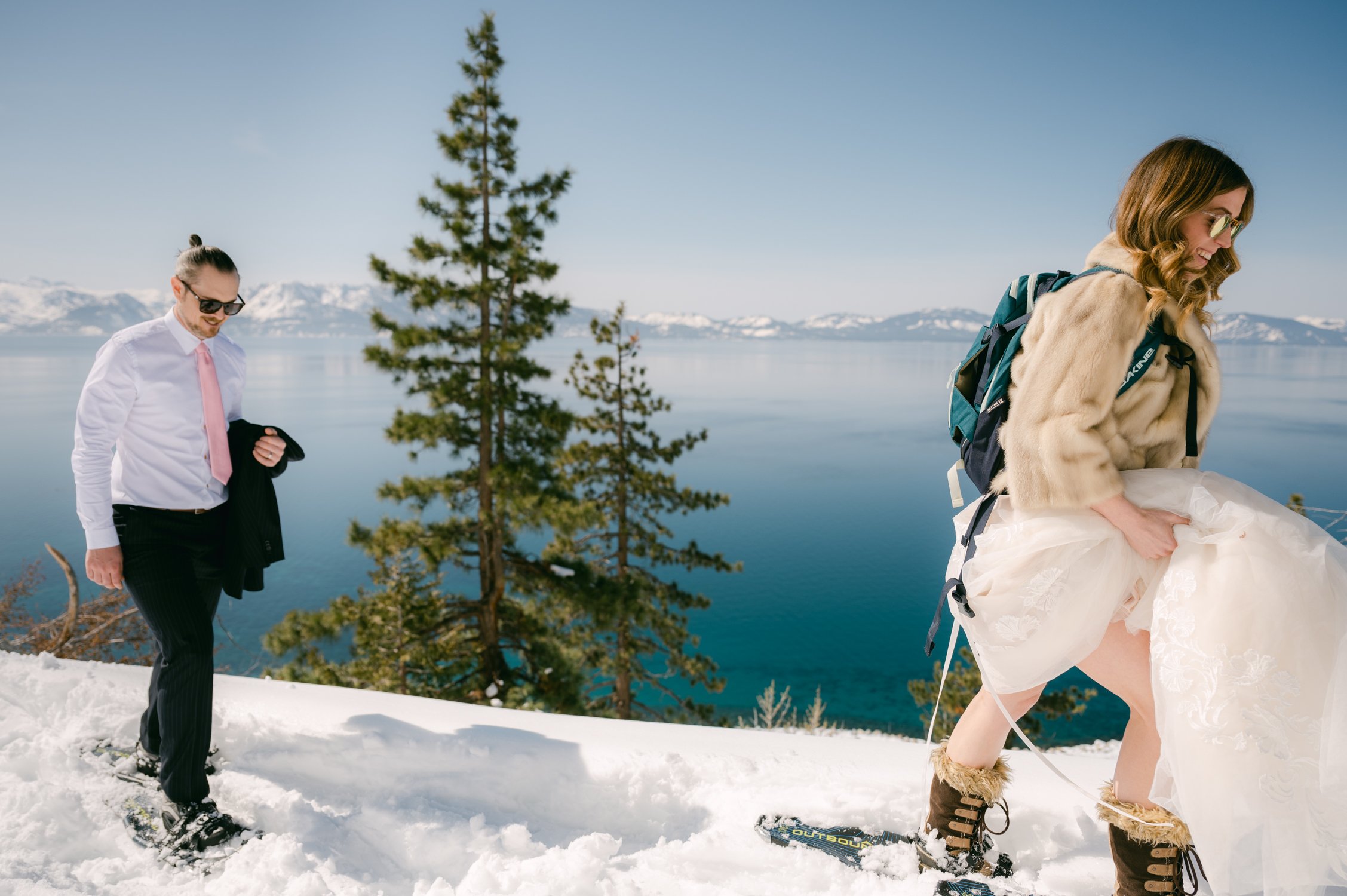 An elopement during a historic winter in tahoe, photo of couple hiking up a mountain 