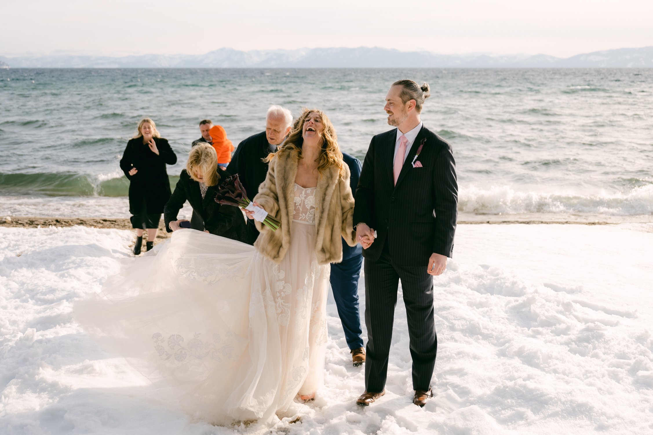 winter tahoe elopement, photo of couple during their ceremony by the lake