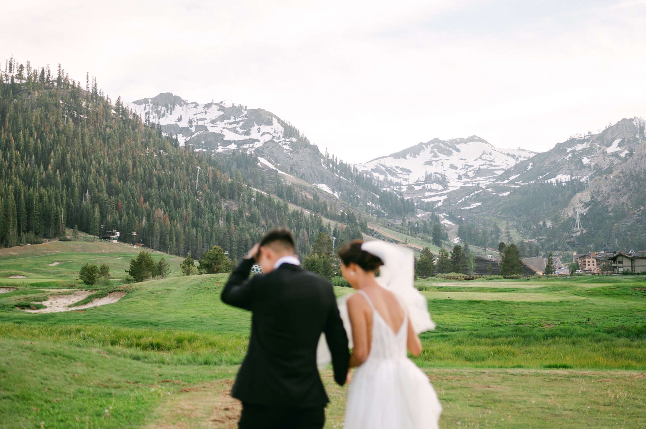olympic valley stables wedding, photo of the newly wed couple walking by the valley