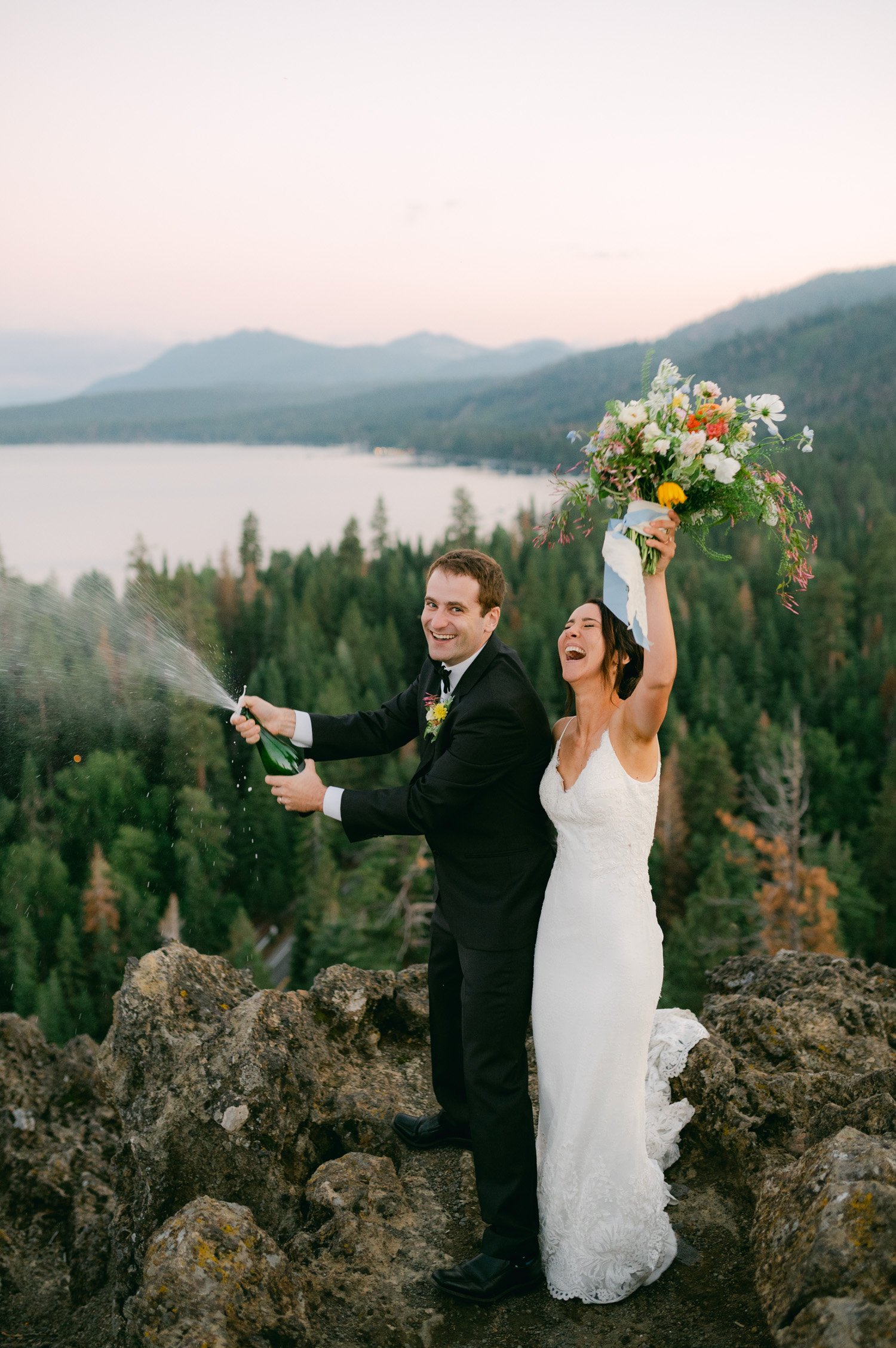 lake tahoe wedding, photo of the newly wed couple opening a champagne with the view of the lake