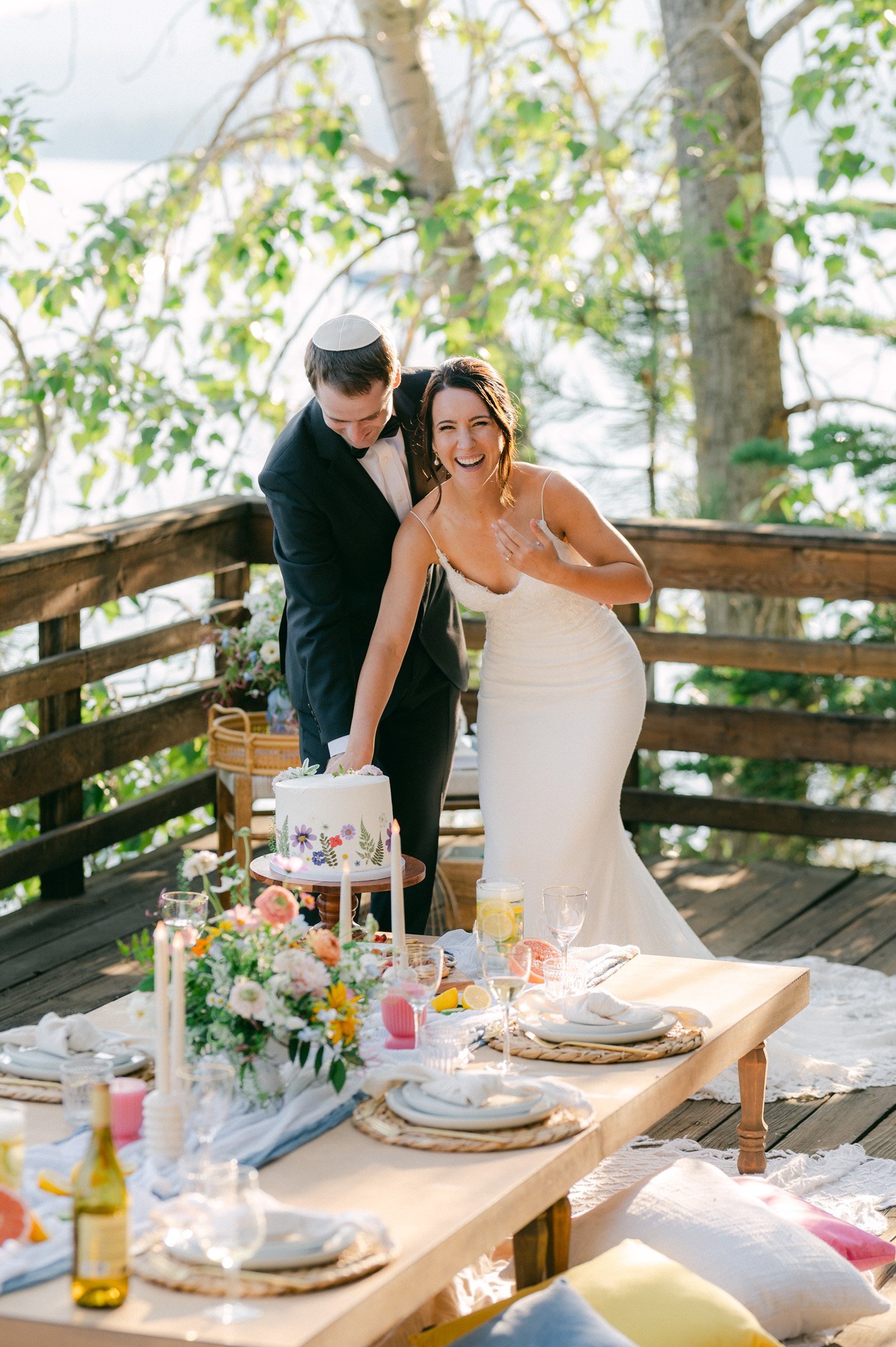 lake tahoe wedding, photo of the newly wed couple slicing their wedding cake