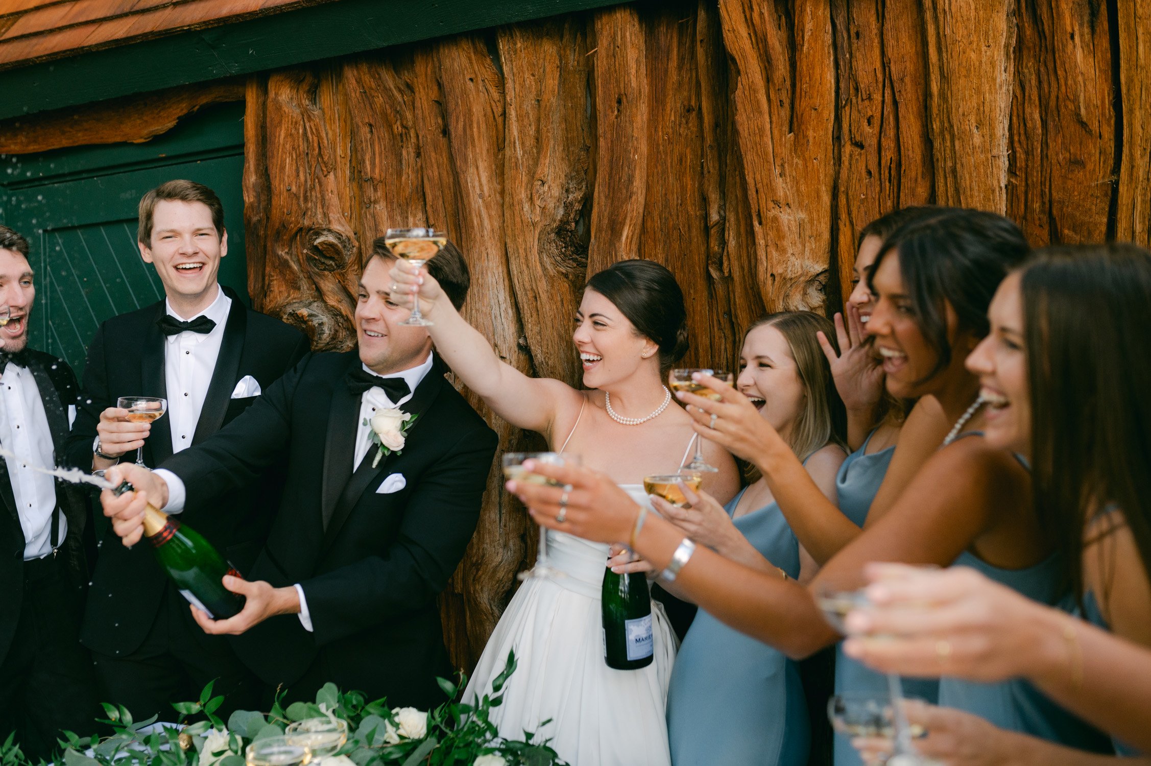 Valhalla Lake Tahoe wedding, photo of the newly wed couple doing a toast with their wedding party