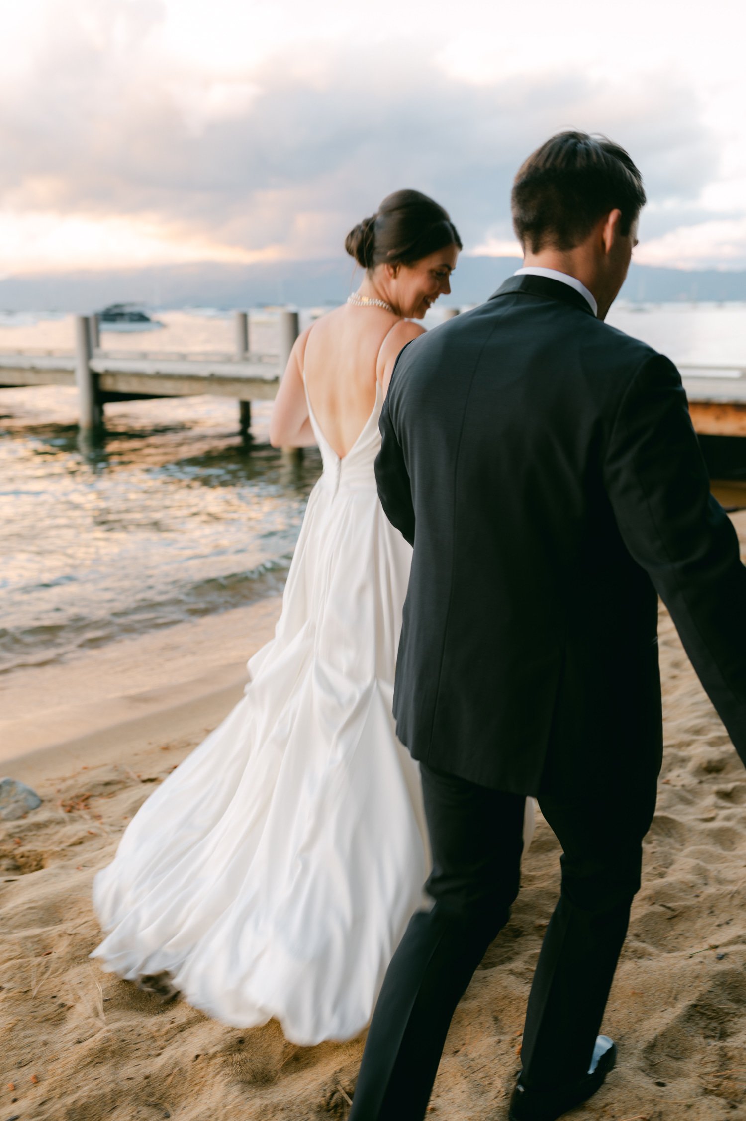 Valhalla Lake Tahoe wedding, photo of the newly wed couple walking by the dock