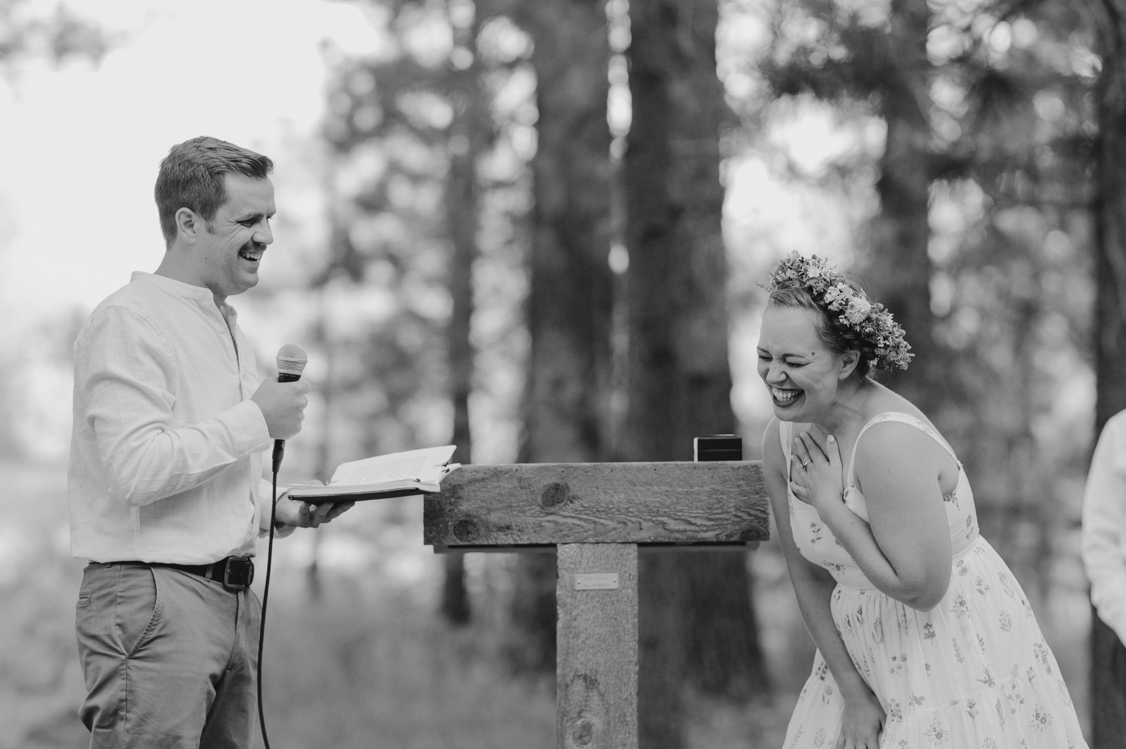 graeagle corner barn wedding, photo of the groom giving a speech and the bride laughing