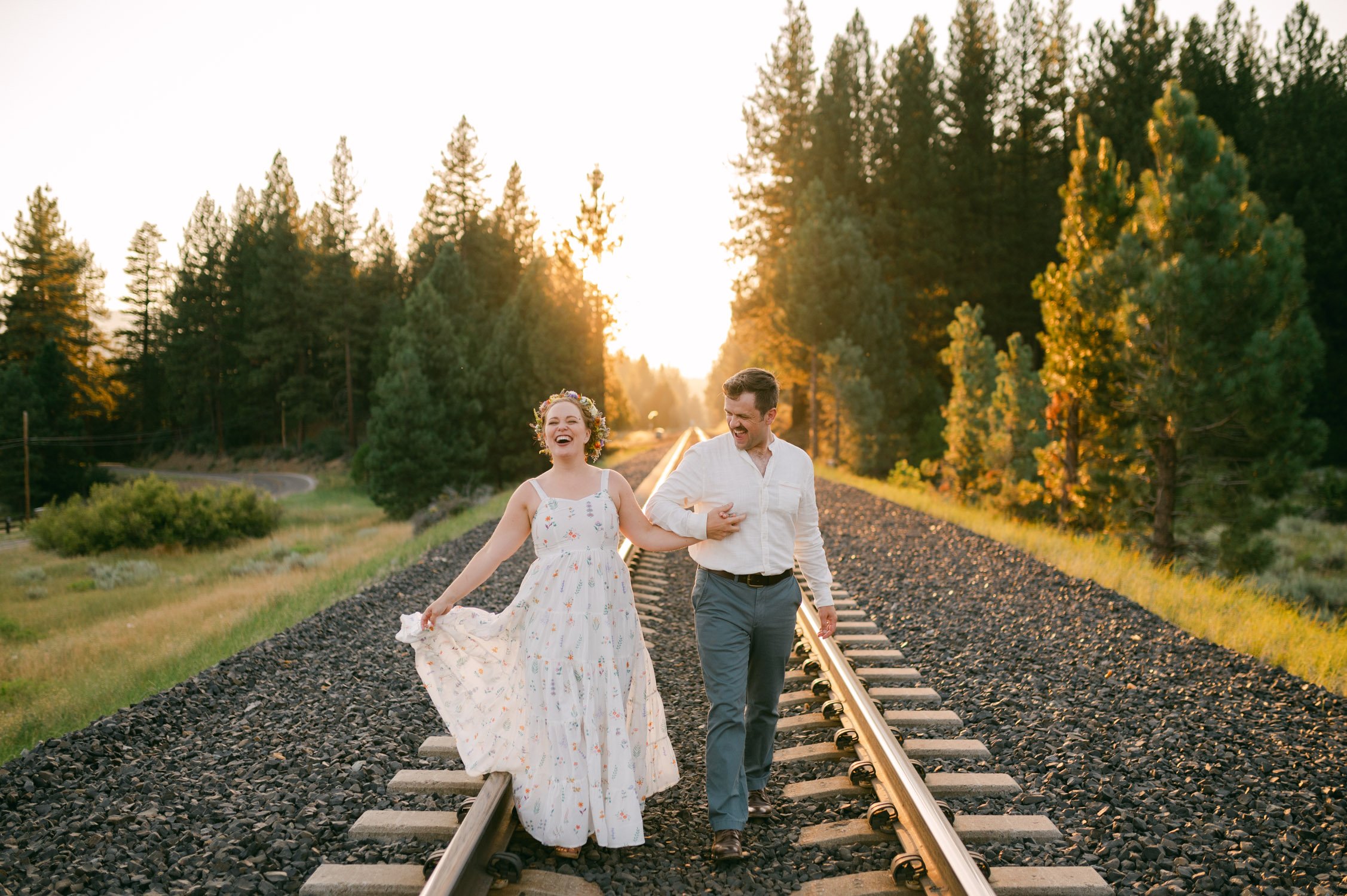 graeagle corner barn wedding, photo of the newlywed couple walking on the railway during their sunset photoshoot