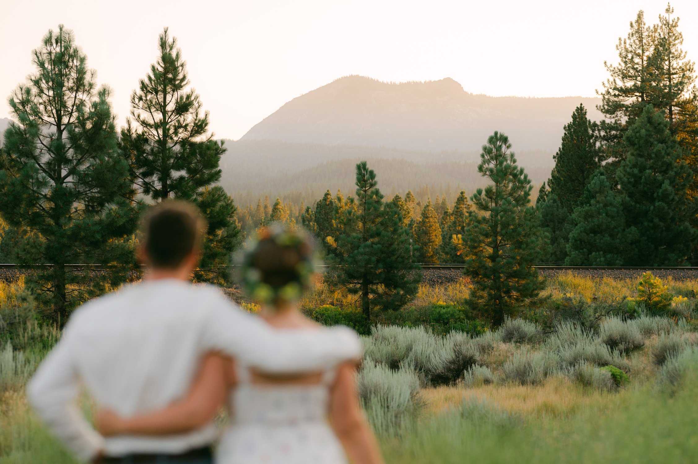 graeagle corner barn wedding, photo of the newlywed couple enjoying the mountain view during their sunset portraits