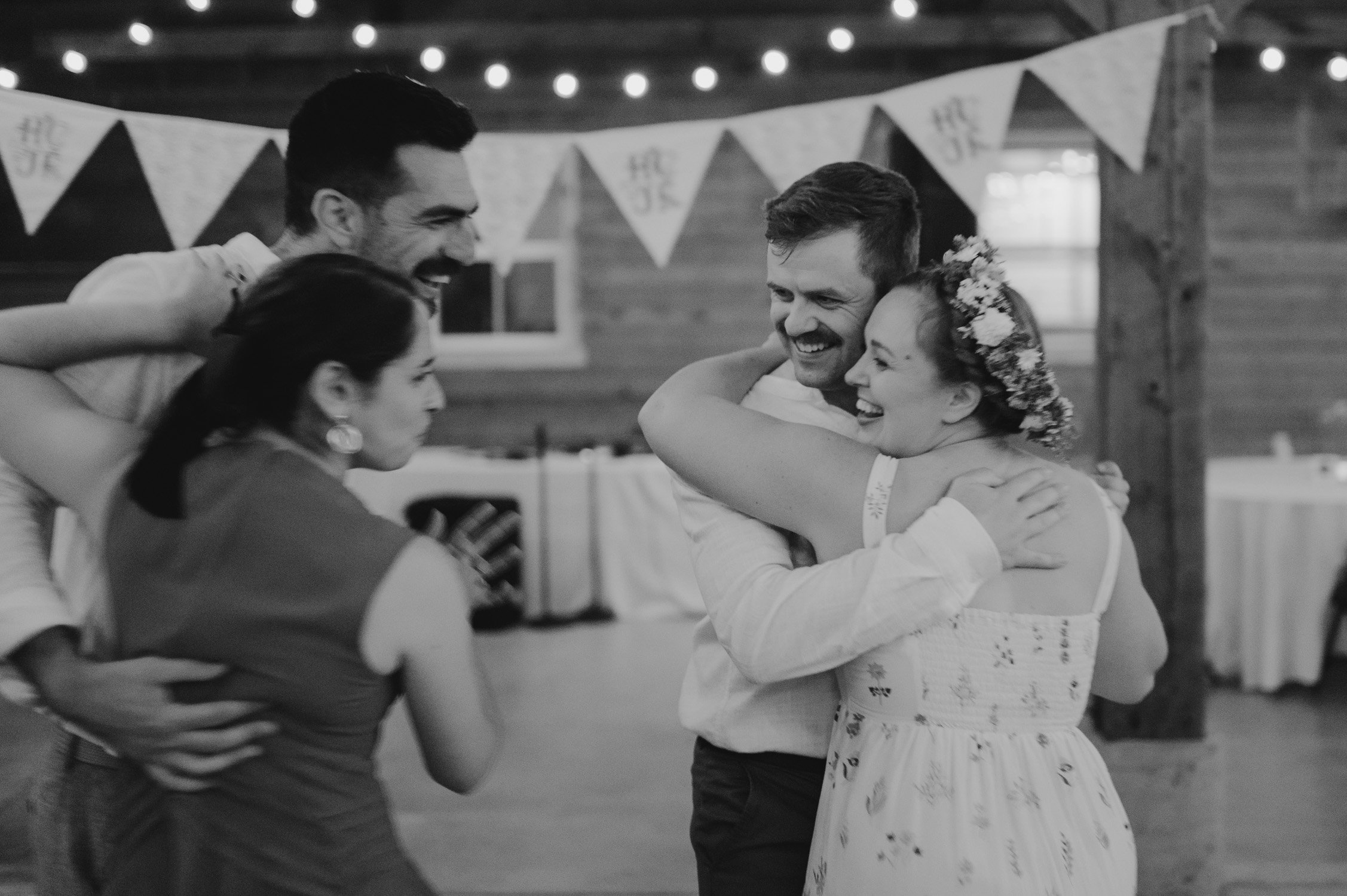 graeagle corner barn wedding, photo of the newlywed couple and guests dancing and hugging