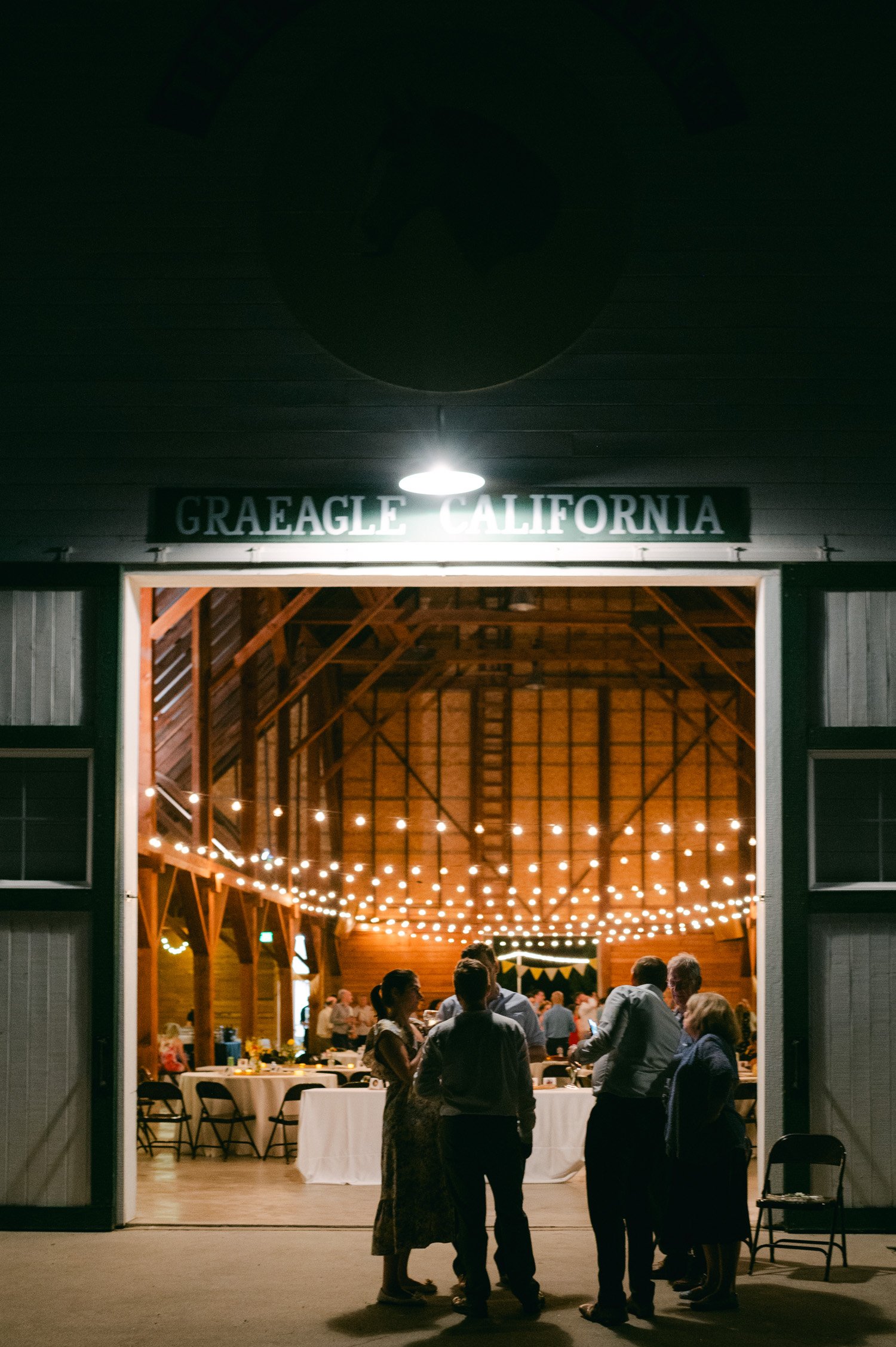 graeagle corner barn wedding, photo of the wedding venue at night with twinkling lights