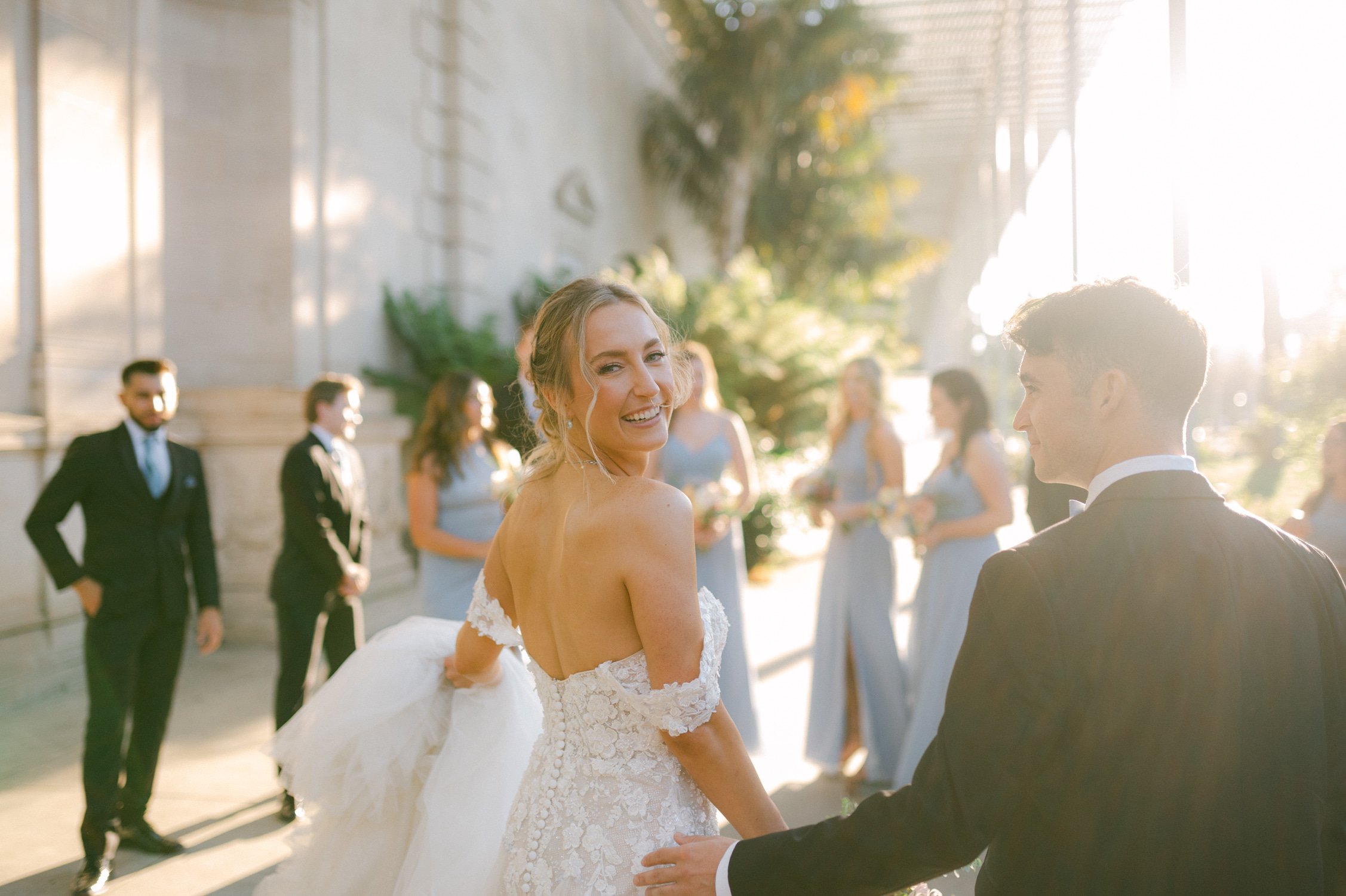 California academy of Sciences in San Francisco Wedding, photo of the couple walking to their wedding party