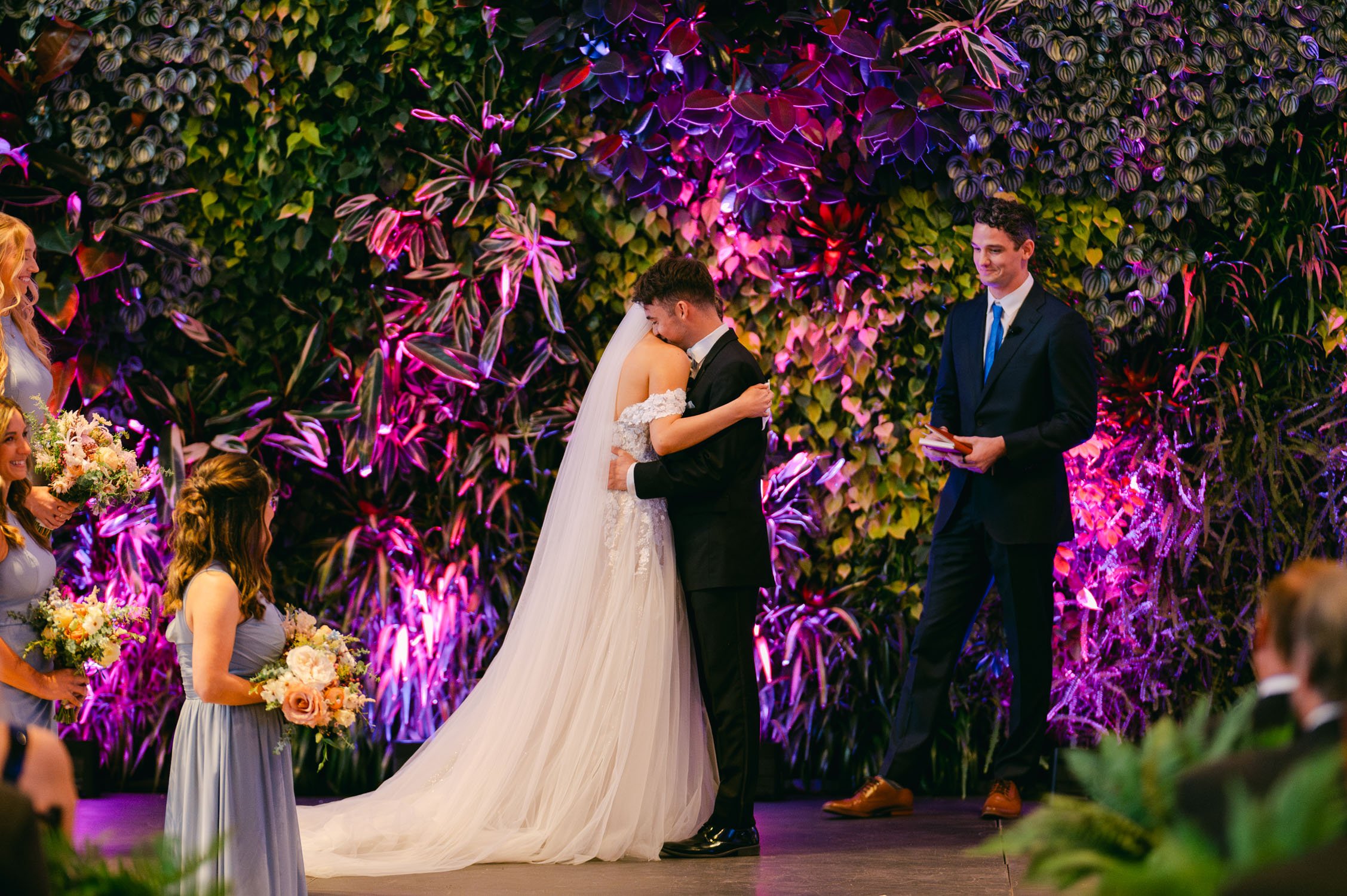 California academy of Sciences in San Francisco Wedding, photo of the newly wed couple hugging during their ceremony