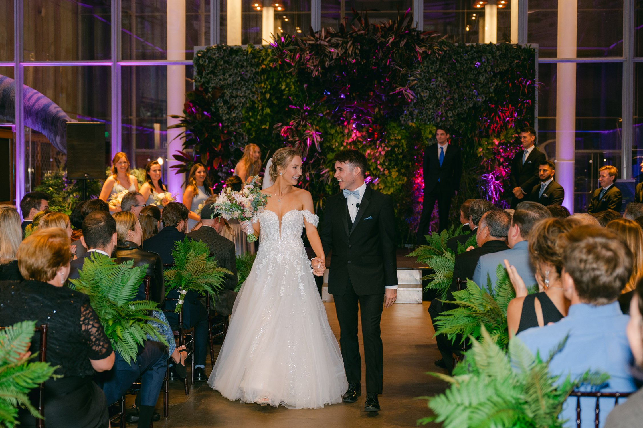 California academy of Sciences in San Francisco Wedding, photo of the newly wed couple after their ceremony walking down the aisle