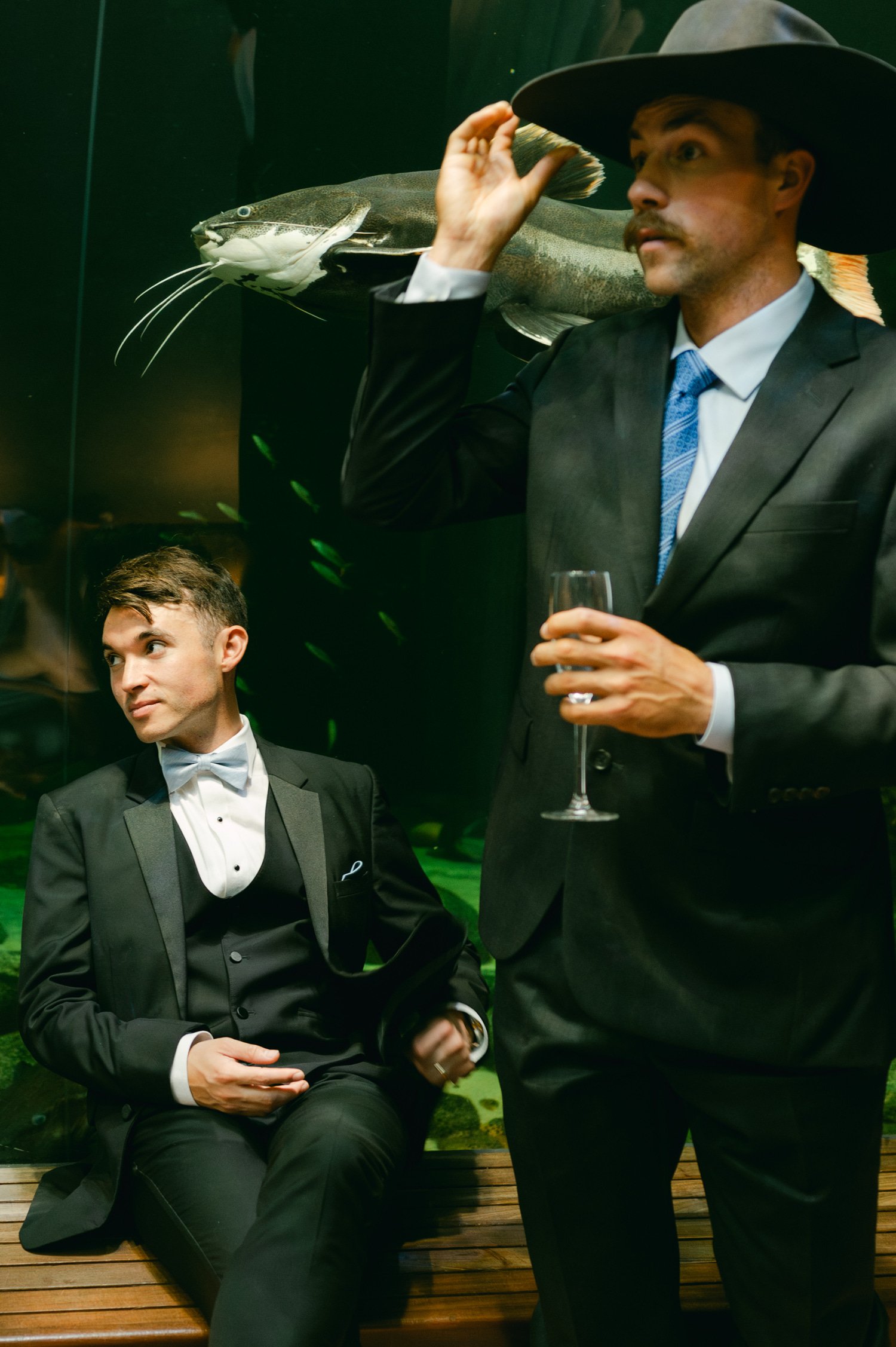 California academy of Sciences in San Francisco Wedding, photo of the groom and a guest with a drink in his hand during the cocktail hour