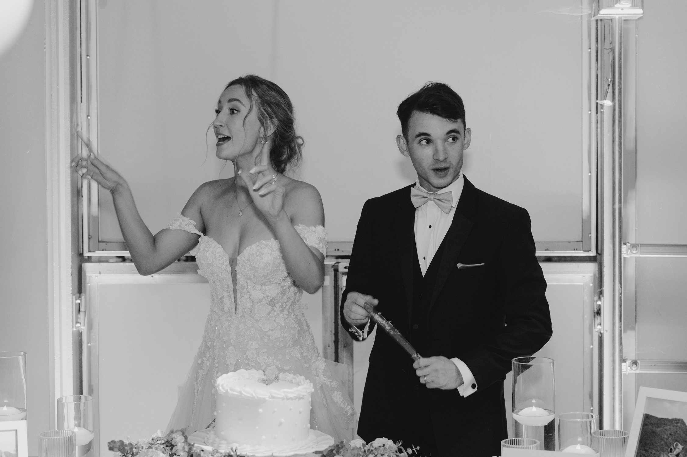 California academy of Sciences in San Francisco Wedding, photo of the newly wed couple singing while slicing their wedding cake