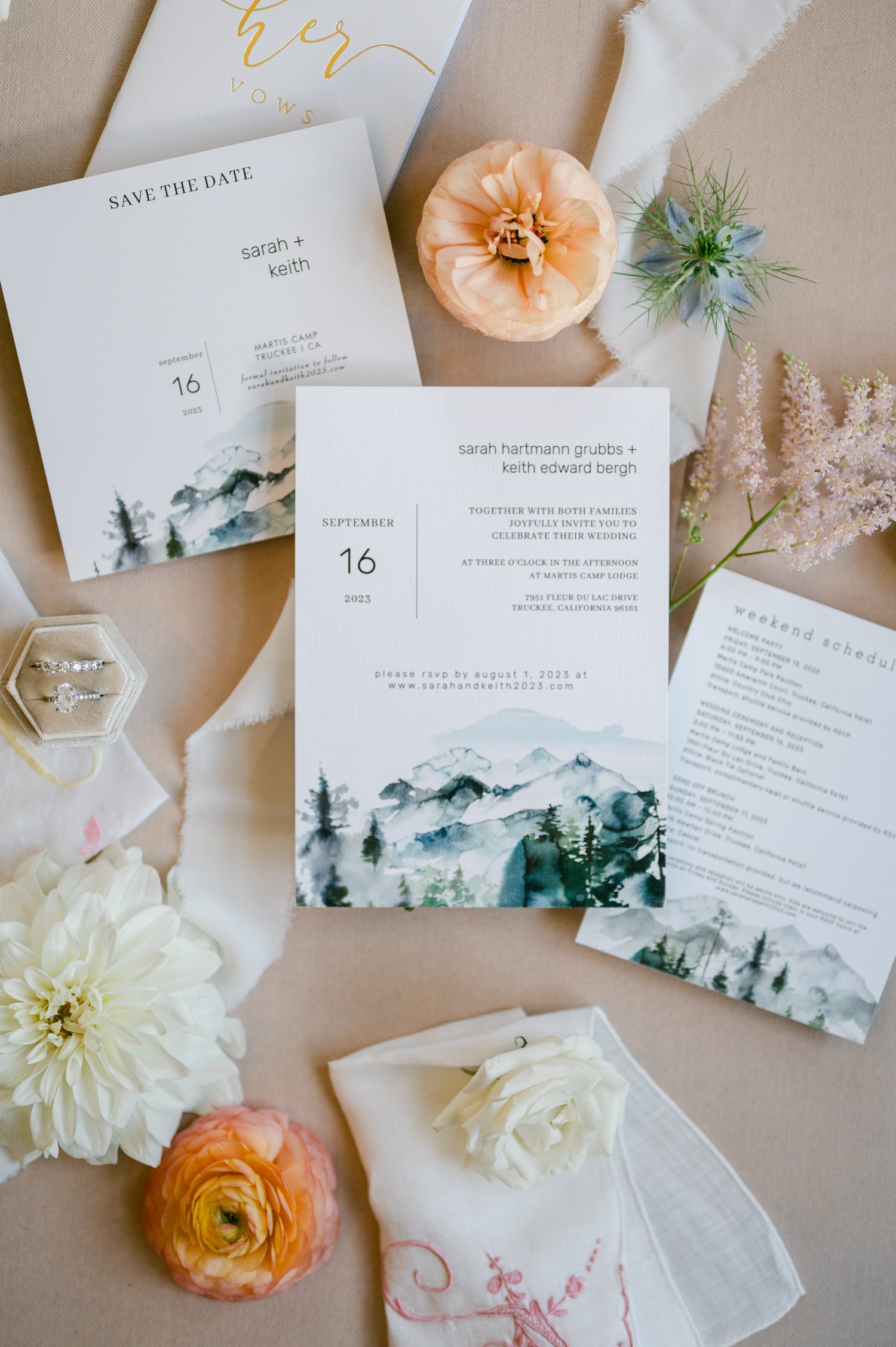 Martis Camp Wedding, photo of the wedding invitation with a mountain landscape design, wedding rings, and flowers