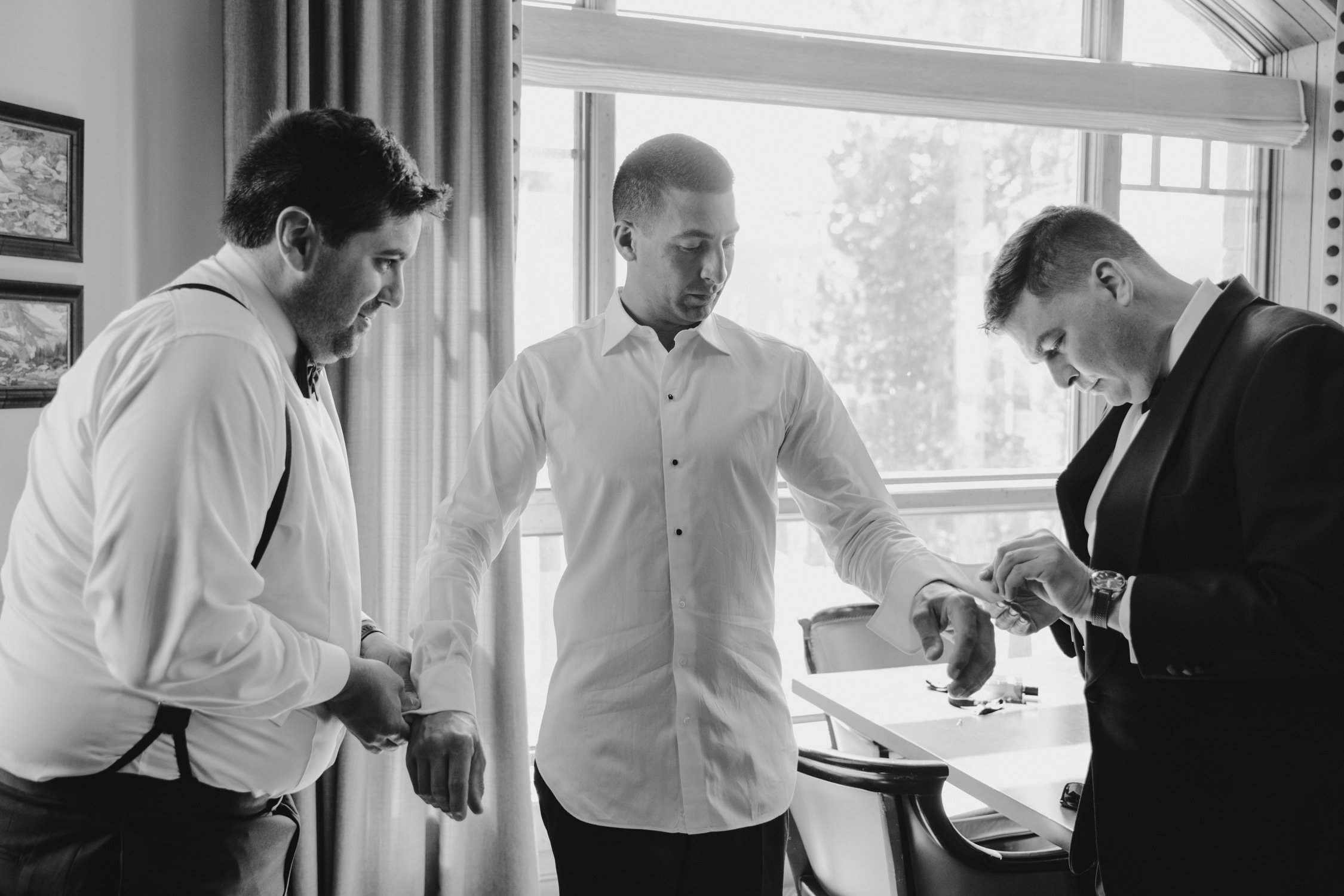 Martis Camp Wedding, photo of the groomsmen fixing the groom’s suit