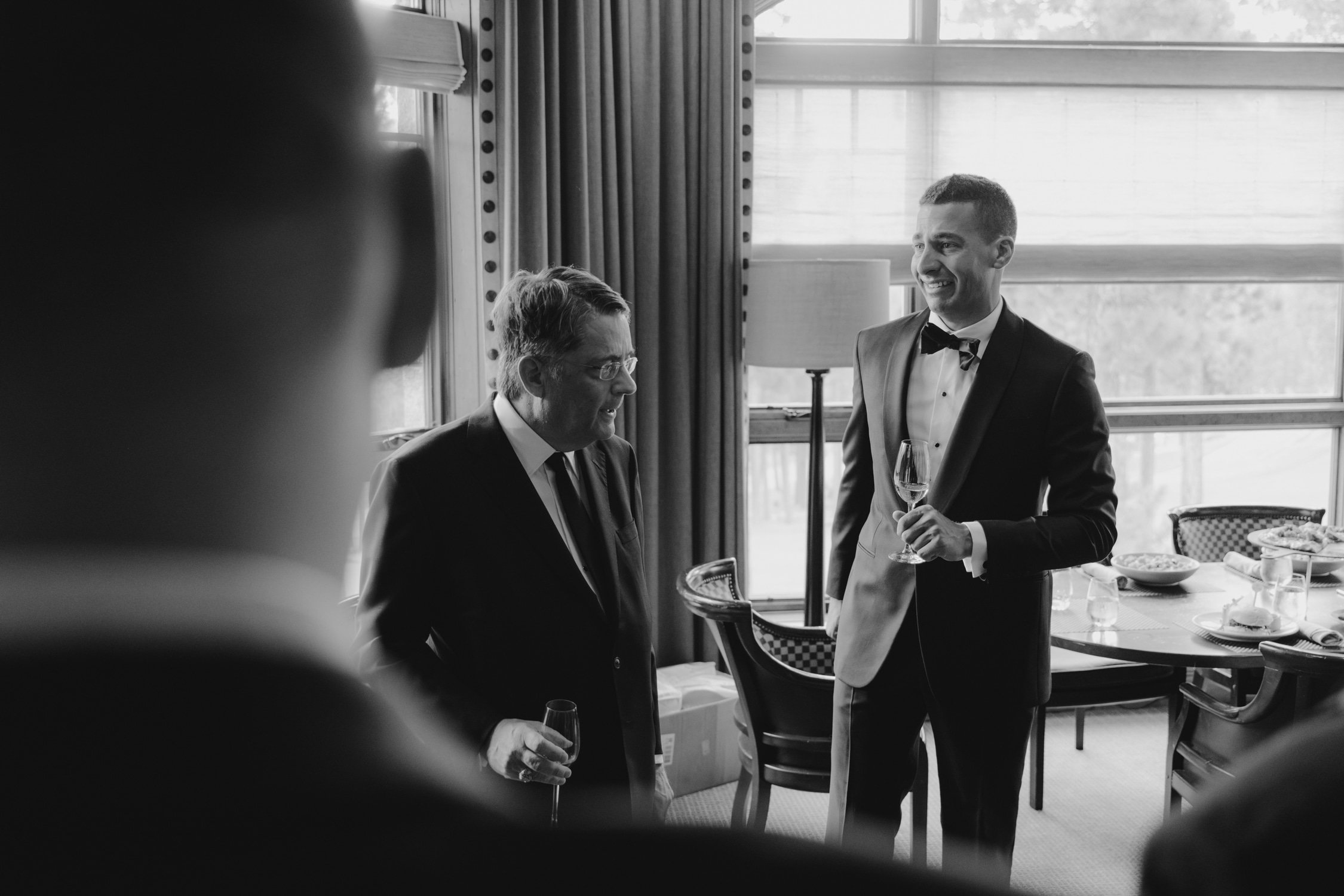 Martis Camp Wedding, photo of the groom and his dad holding a champagne glass preparing for the wedding