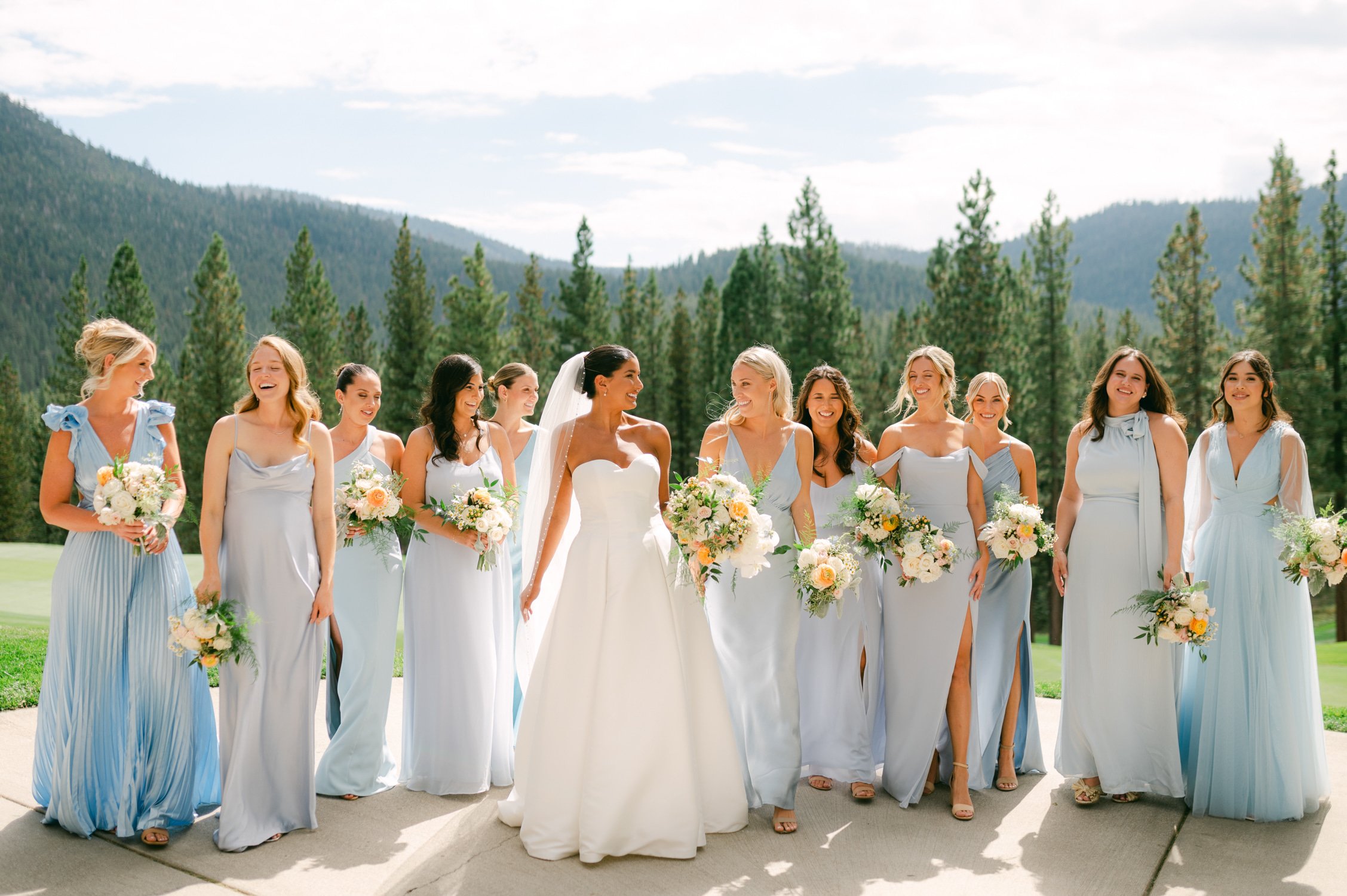 Martis Camp Wedding, photo of the bride with her bridesmaids wearing blue dresses